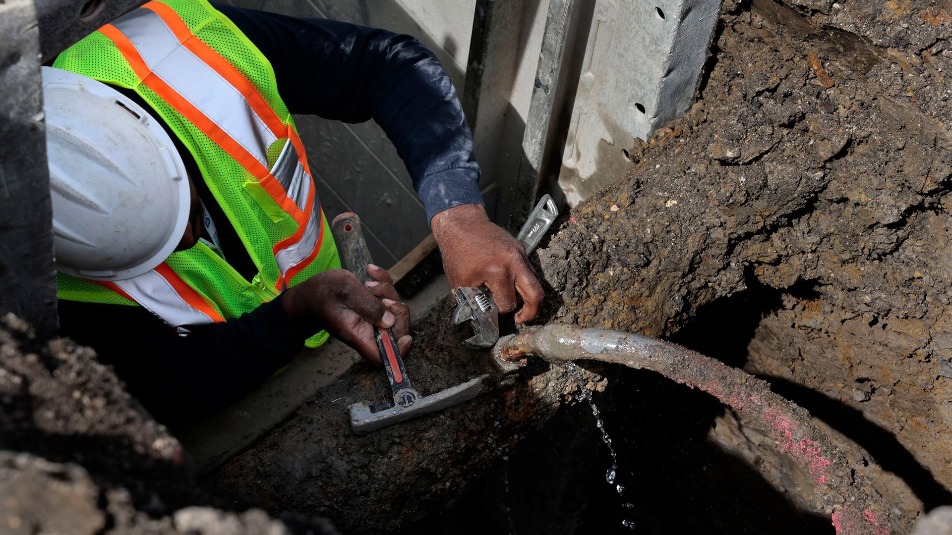 A worker repairing a leaking lead service pipe in Chicago in April 2023.