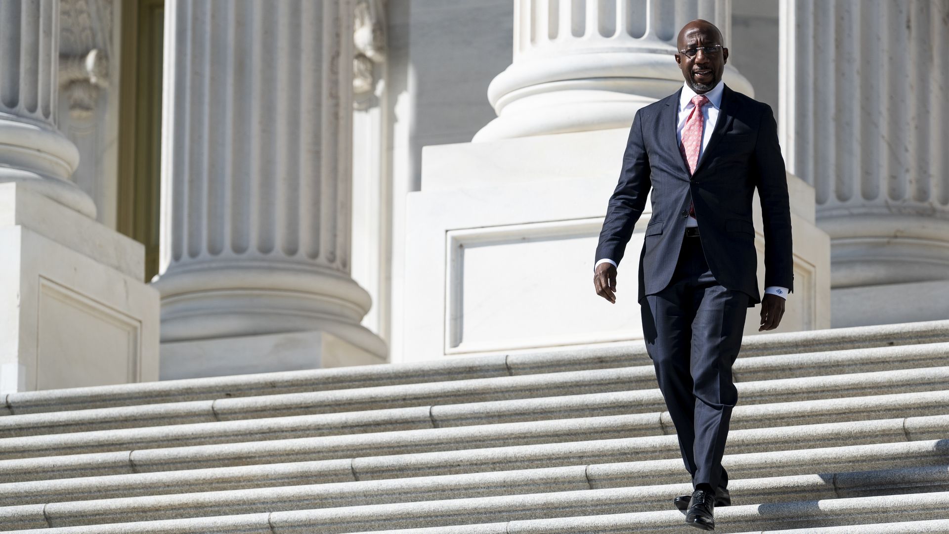 Sen. Raphael Warnock, D-Ga., walks down the Senate steps after a vote in the Capitol on Wednesday, Sept. 29, 2021