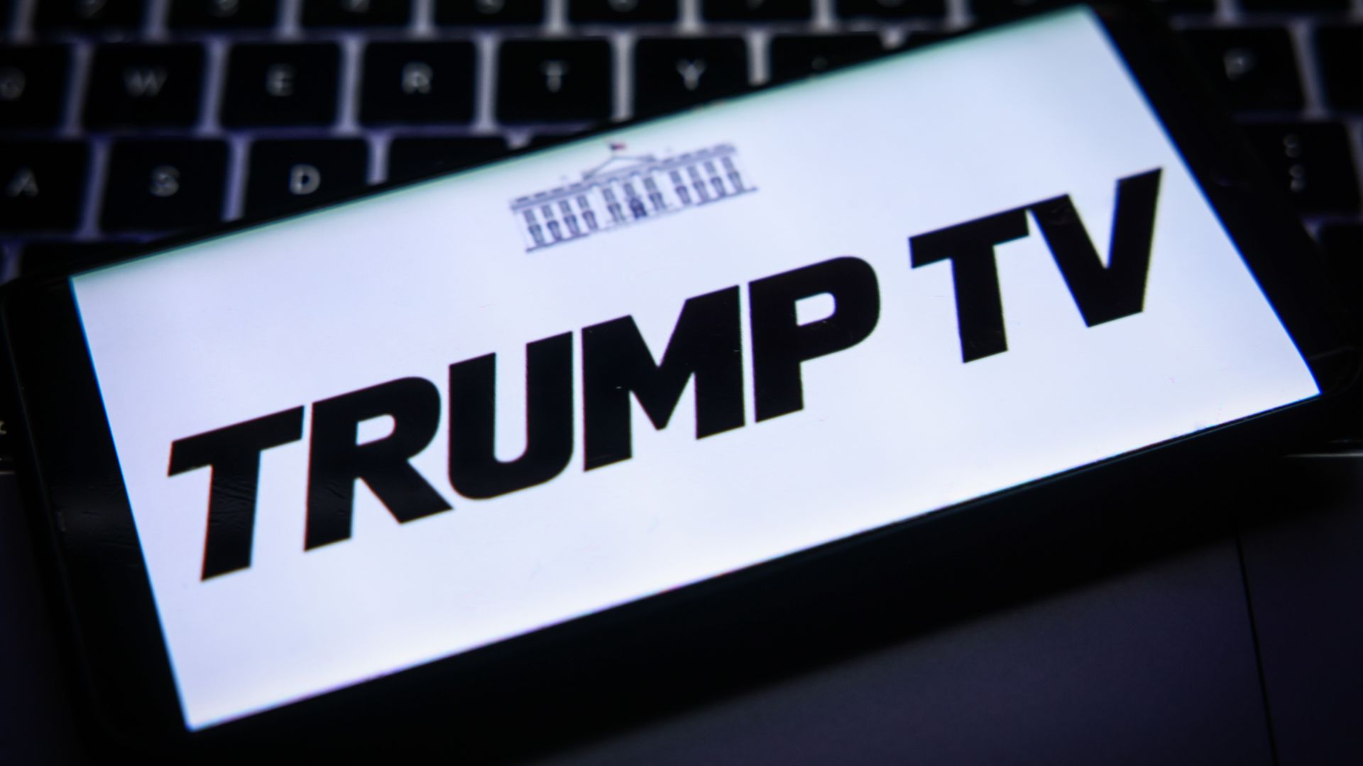 The Trump TV logo displayed on a cellphone screen.