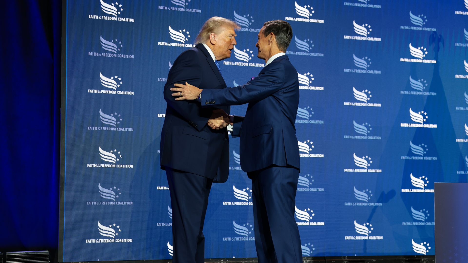 Faith & Freedom Coalition Chairman Ralph Reed greets President Trump onstage.