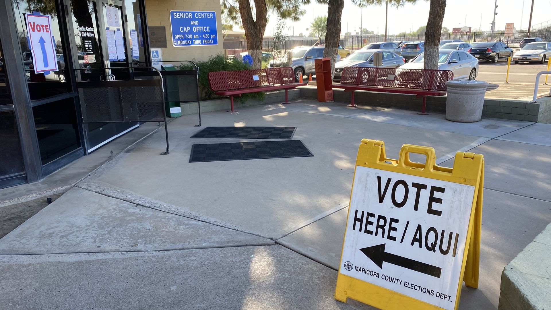 A vote here sign with an arrow pointing toward a polling place
