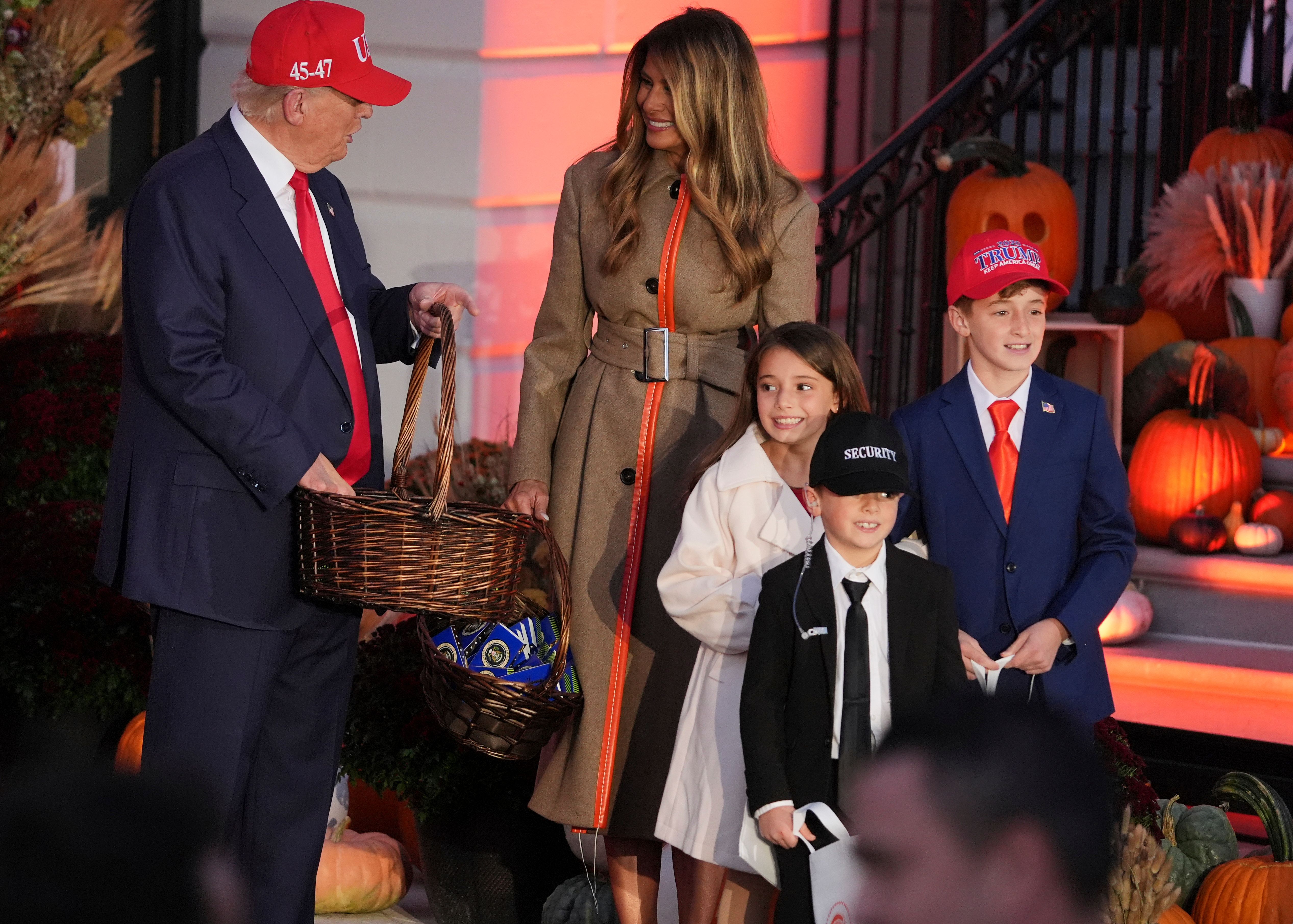 Trick-or-treaters dressed as President Trump, First Lady Melania Trump and a Secret Service agent get candy at a Halloween event at the White House yesterday.