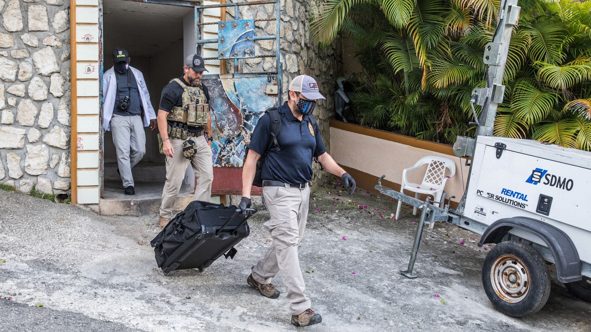 FBI agents exiting the residence of late Haitian President Jovenel Moise in Port-au-Prince on July 15.