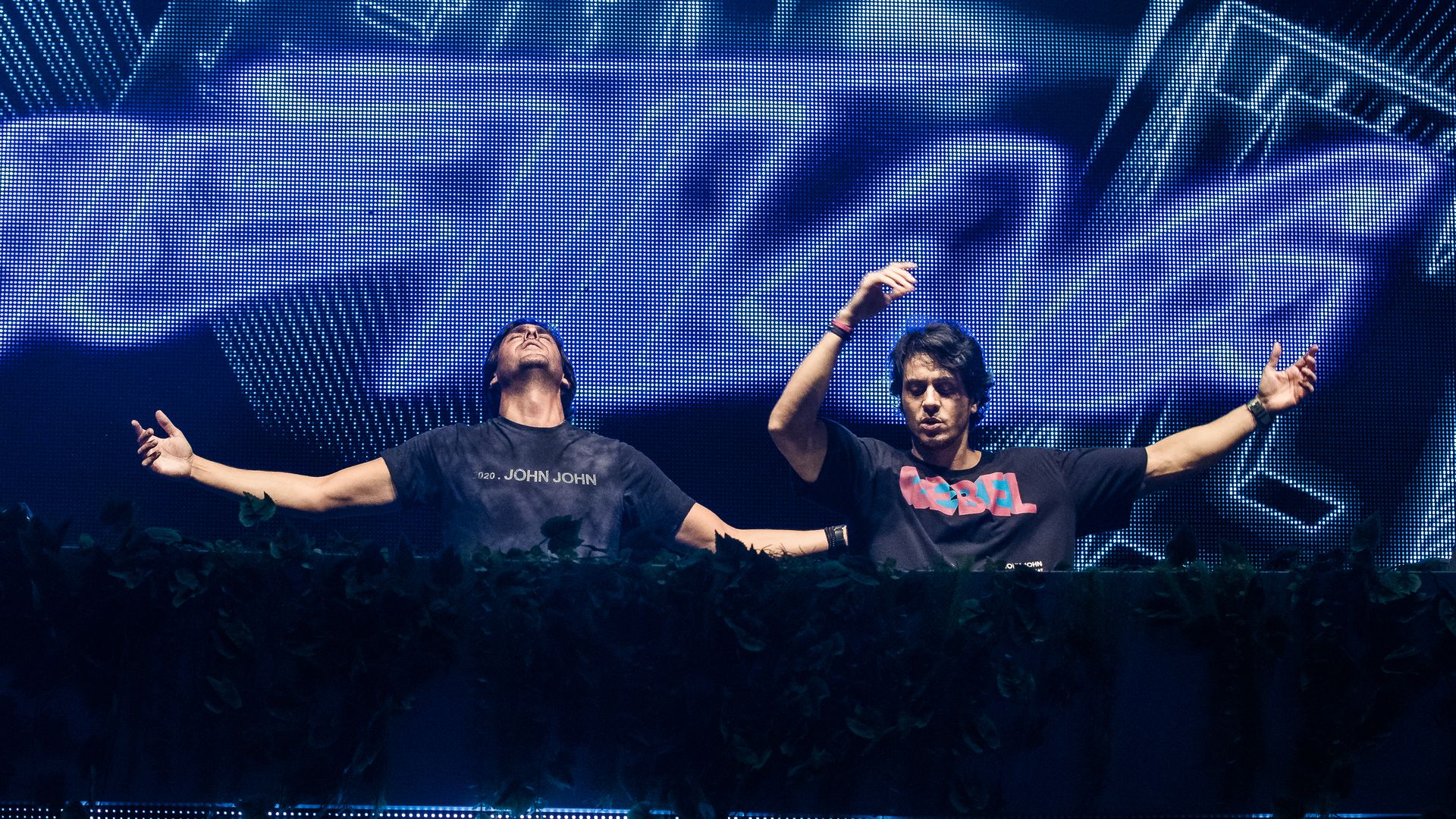 Two DJs performing on a stage