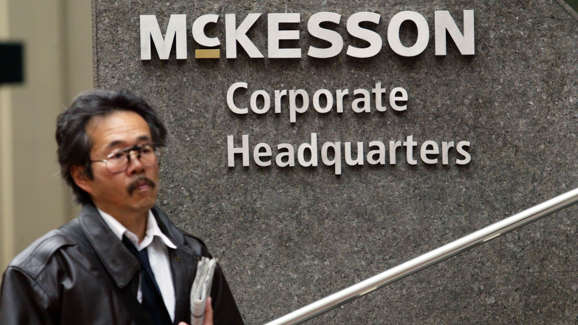 A man in front of the McKesson headquarters in San Francisco
