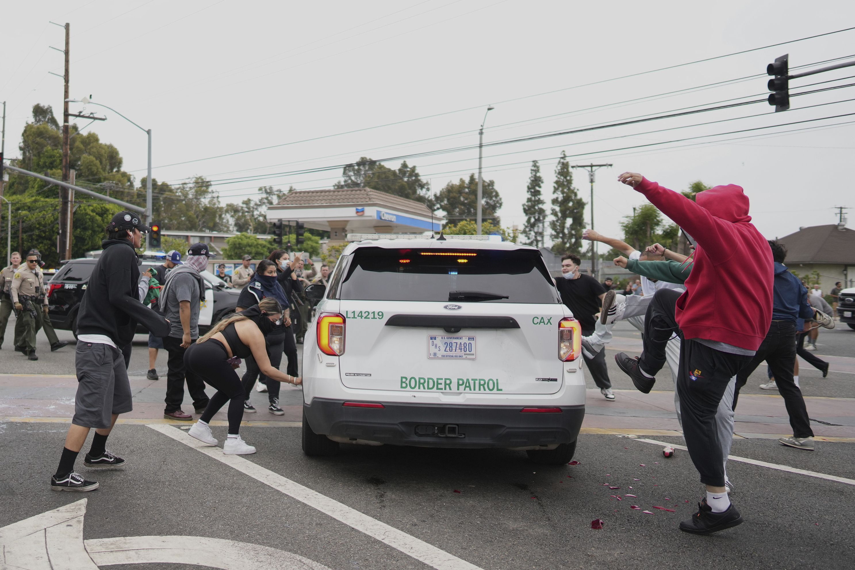 Protesters kick the side of a Border Patrol vehicle during a demonstration over the dozens detained in an operation by federal immigration authorities a day earlier, in Paramount, Calif., Saturday, June 7, 2025. (AP Photo/Eric Thayer)
