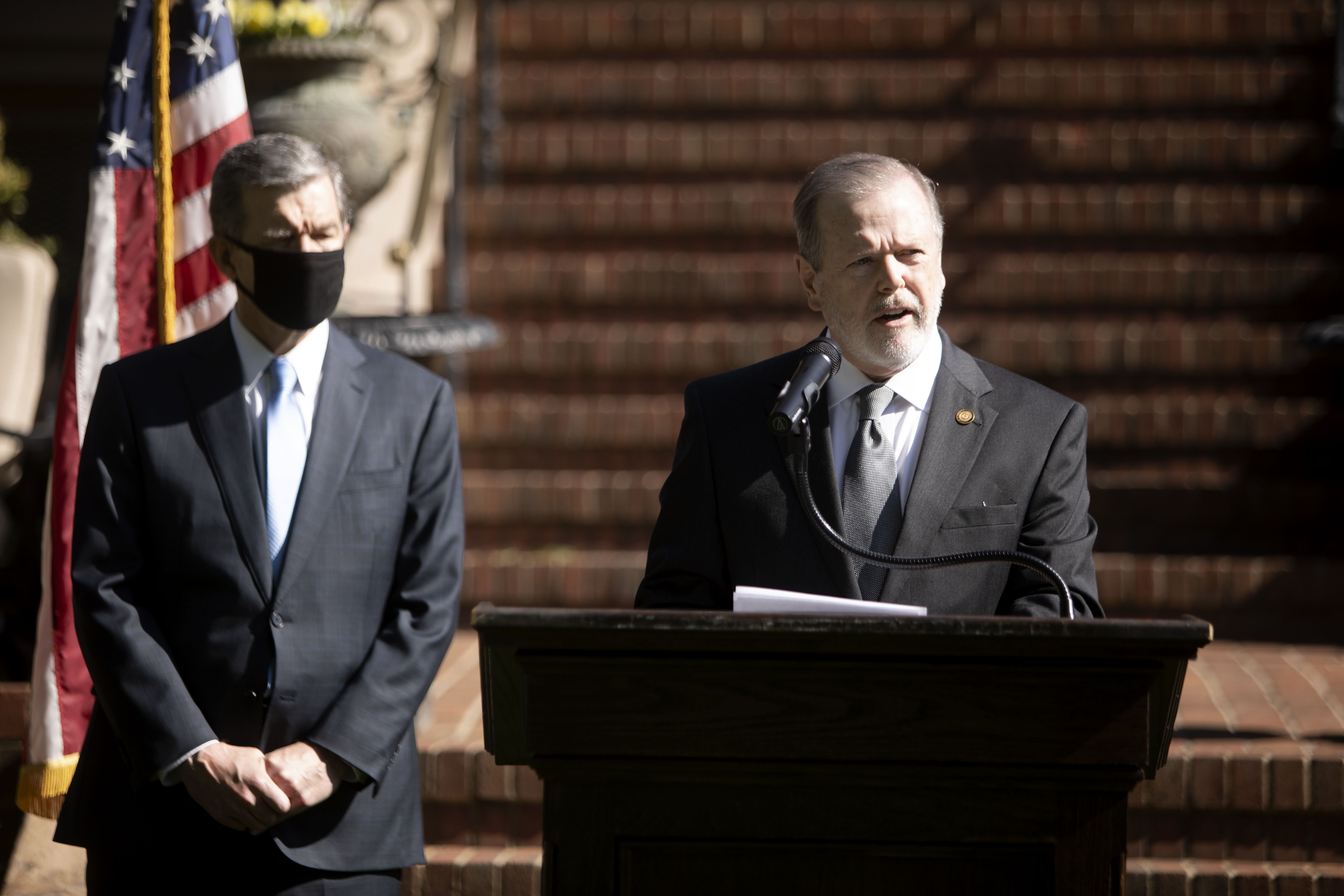 Gov. Roy Cooper, left, and state Senate leader Phil Berger announce Apple's new campus at Research Triangle Park along with House Speaker Tim Moore on Monday, April 26, 2021. Republican leaders of the North Carolina General Assembly, including Berger, filed a motion Thursday evening, June 22, 2023, 