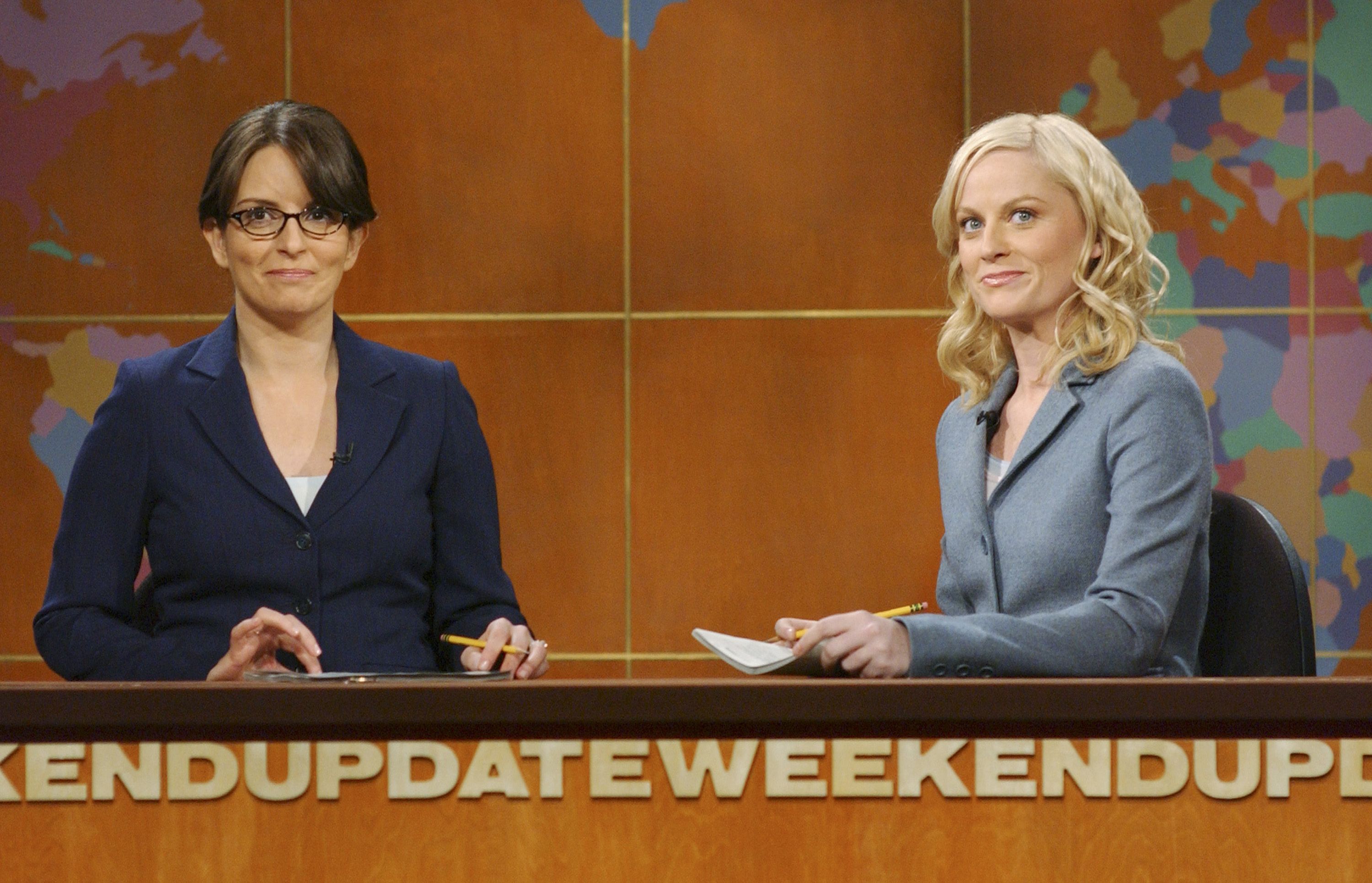 Photo of two actors doing a comedic scene on a set during a television show 