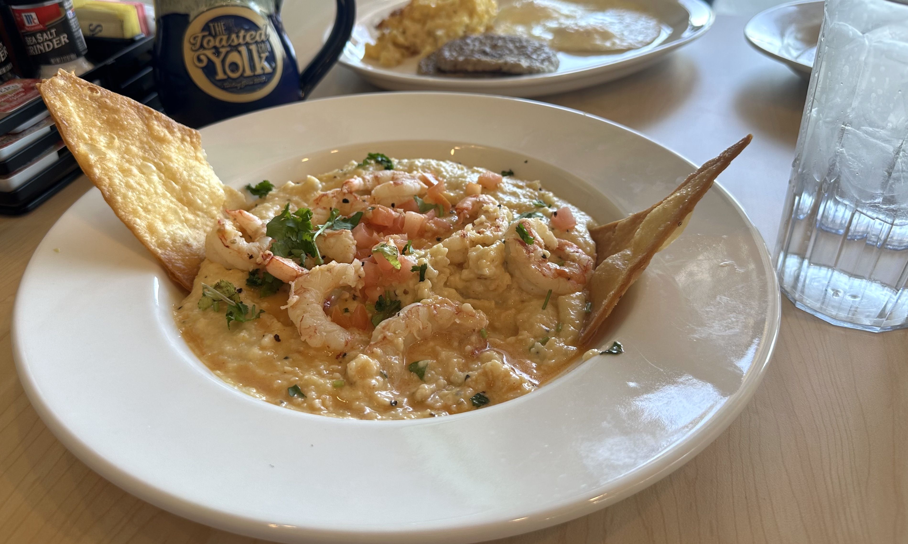 A bowl of shrimp and grits. 