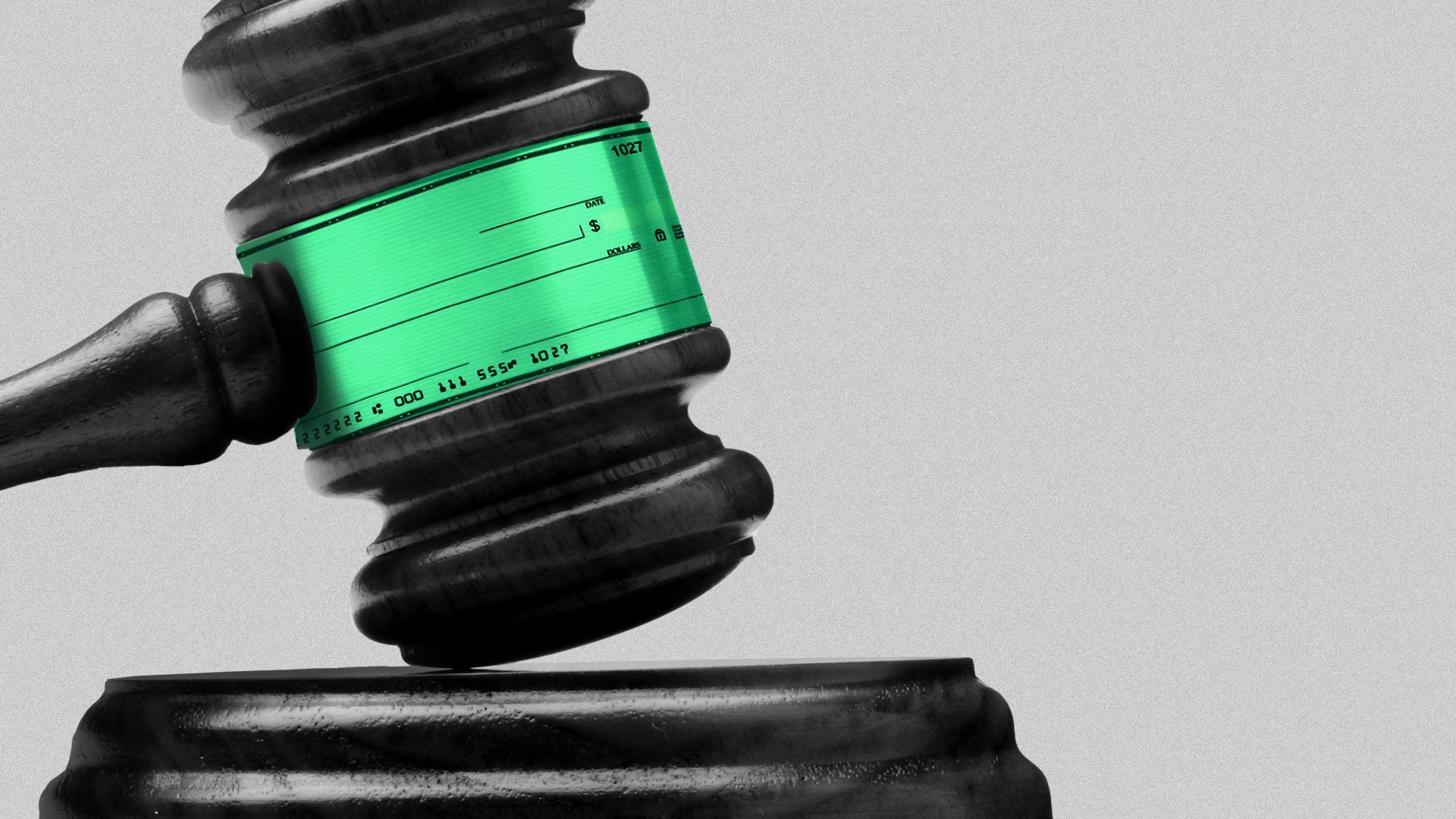 a gavel with a check plastered to it