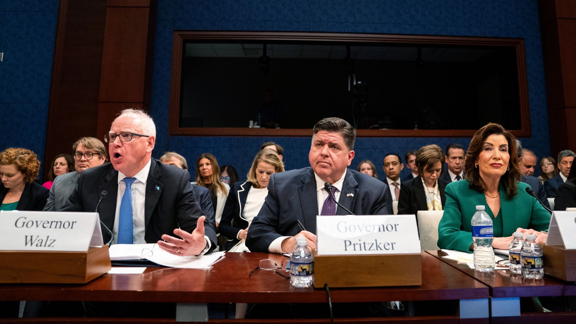 Three people in suits testify at a Congressional hearing