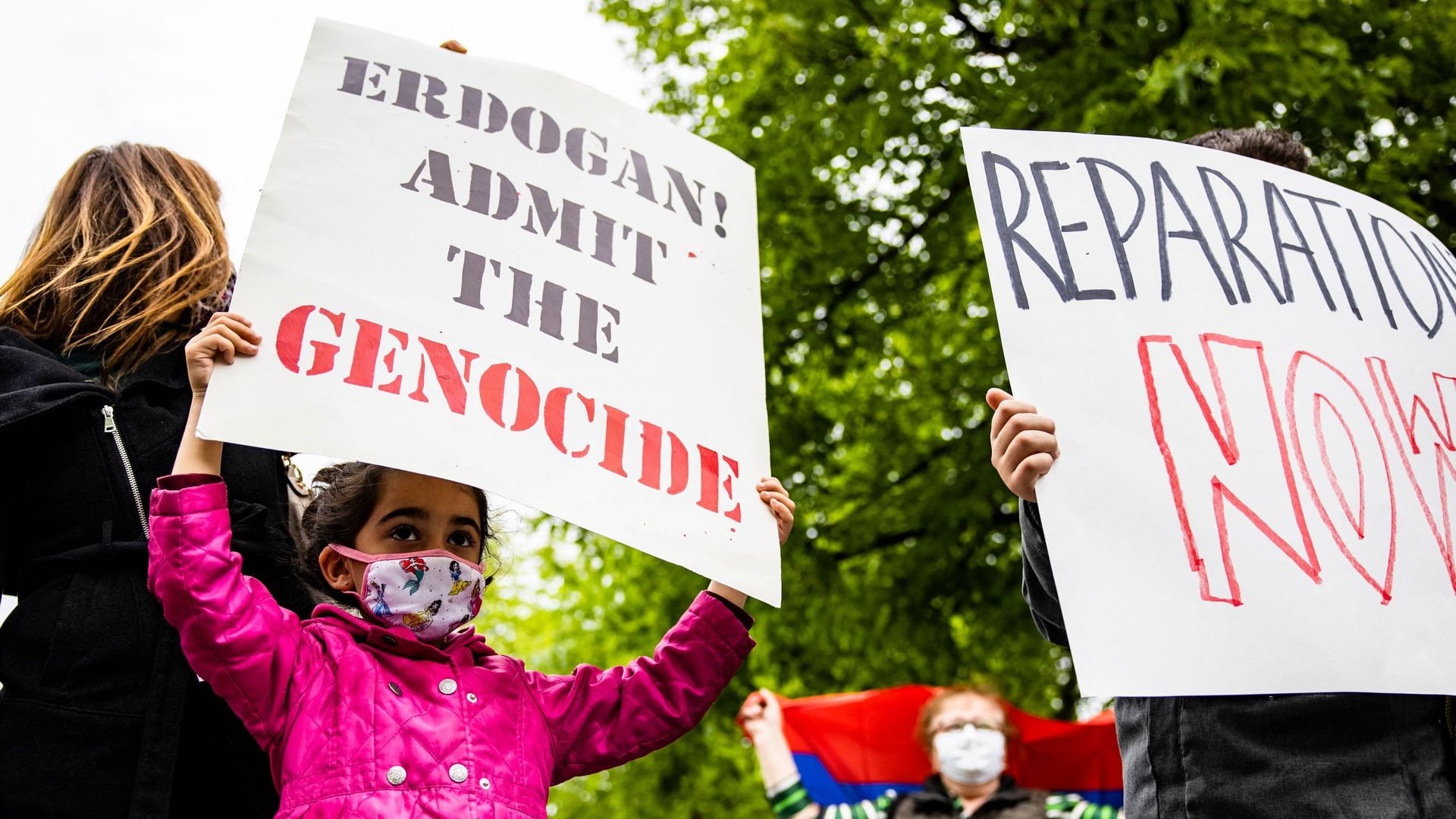 A child is seen joining protestors of a World War I Armenian genocide outside the Turkish ambassador's residence in Washington, D.C.