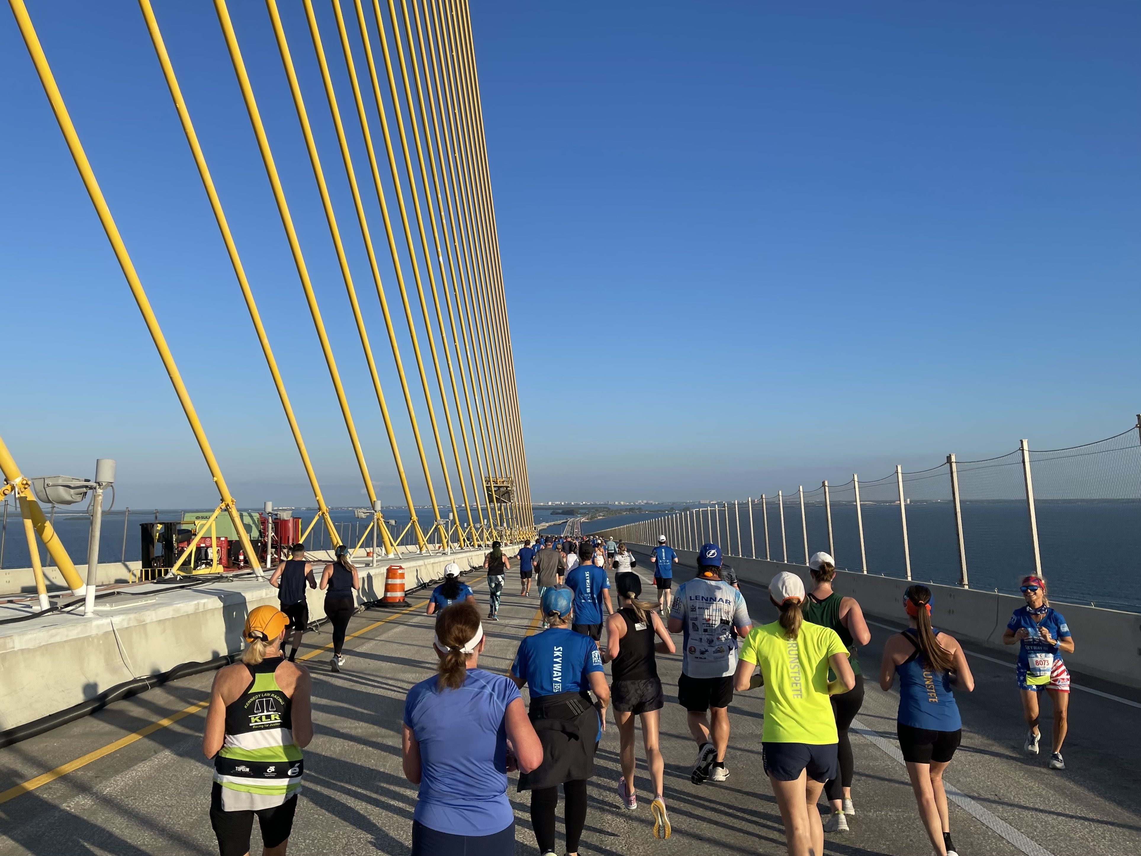 people running on the skyway bridge
