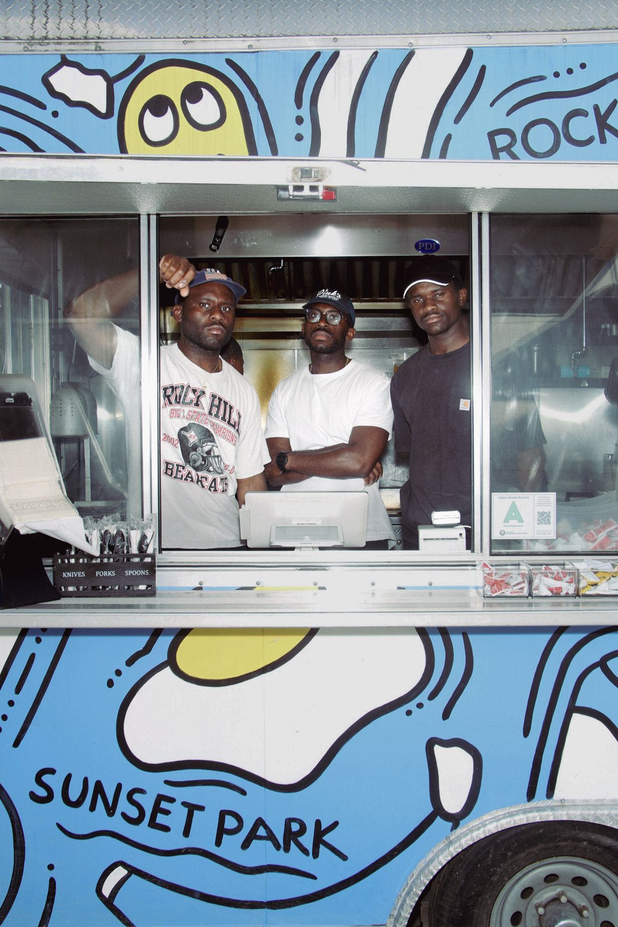 three men inside a food truck