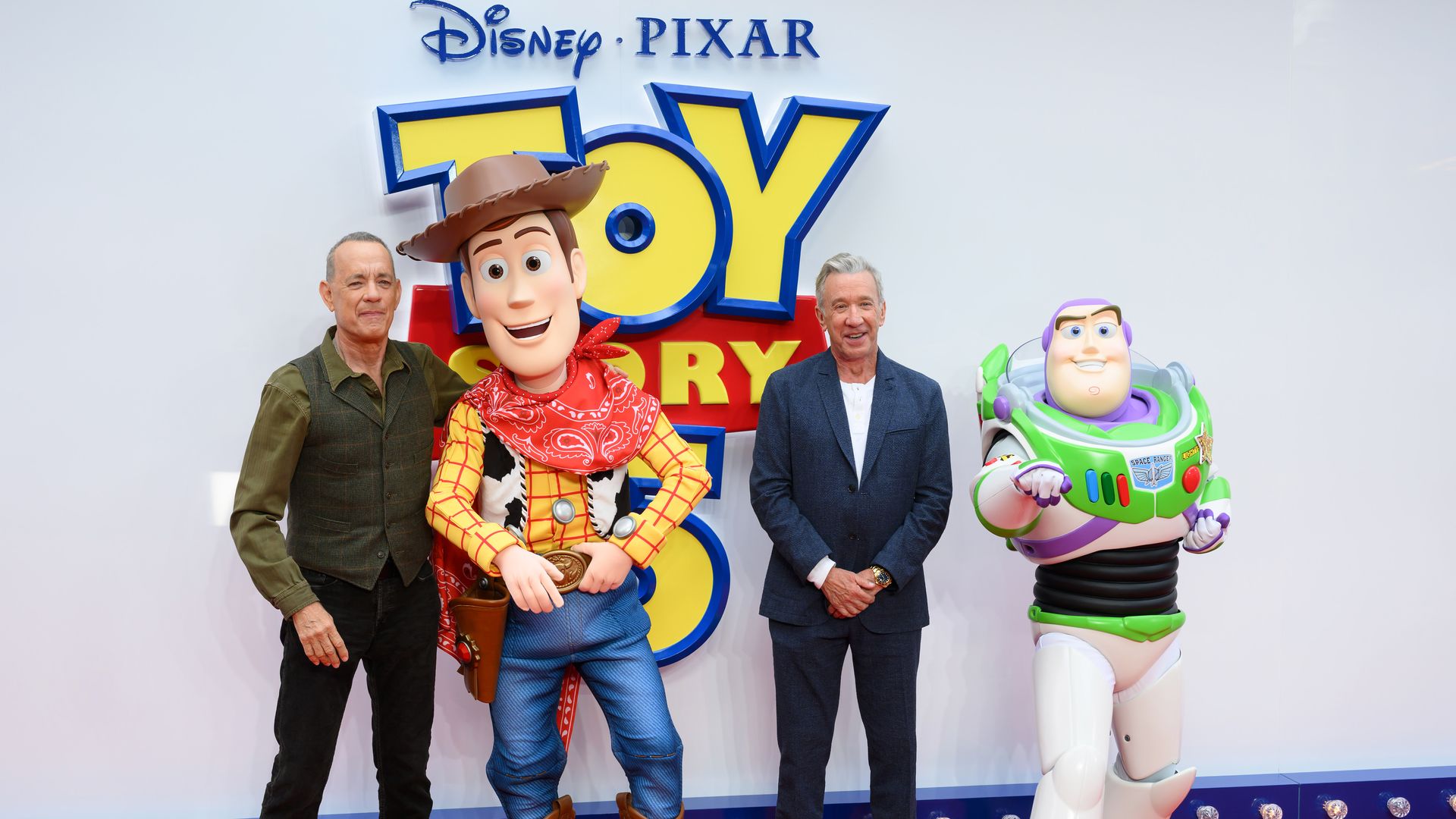 Actors Tom Hanks and Tim Allen stand next life-size versions of cowboy Woody and space ranger Buzz Lightyear, he "Toy Story" characters they voice.