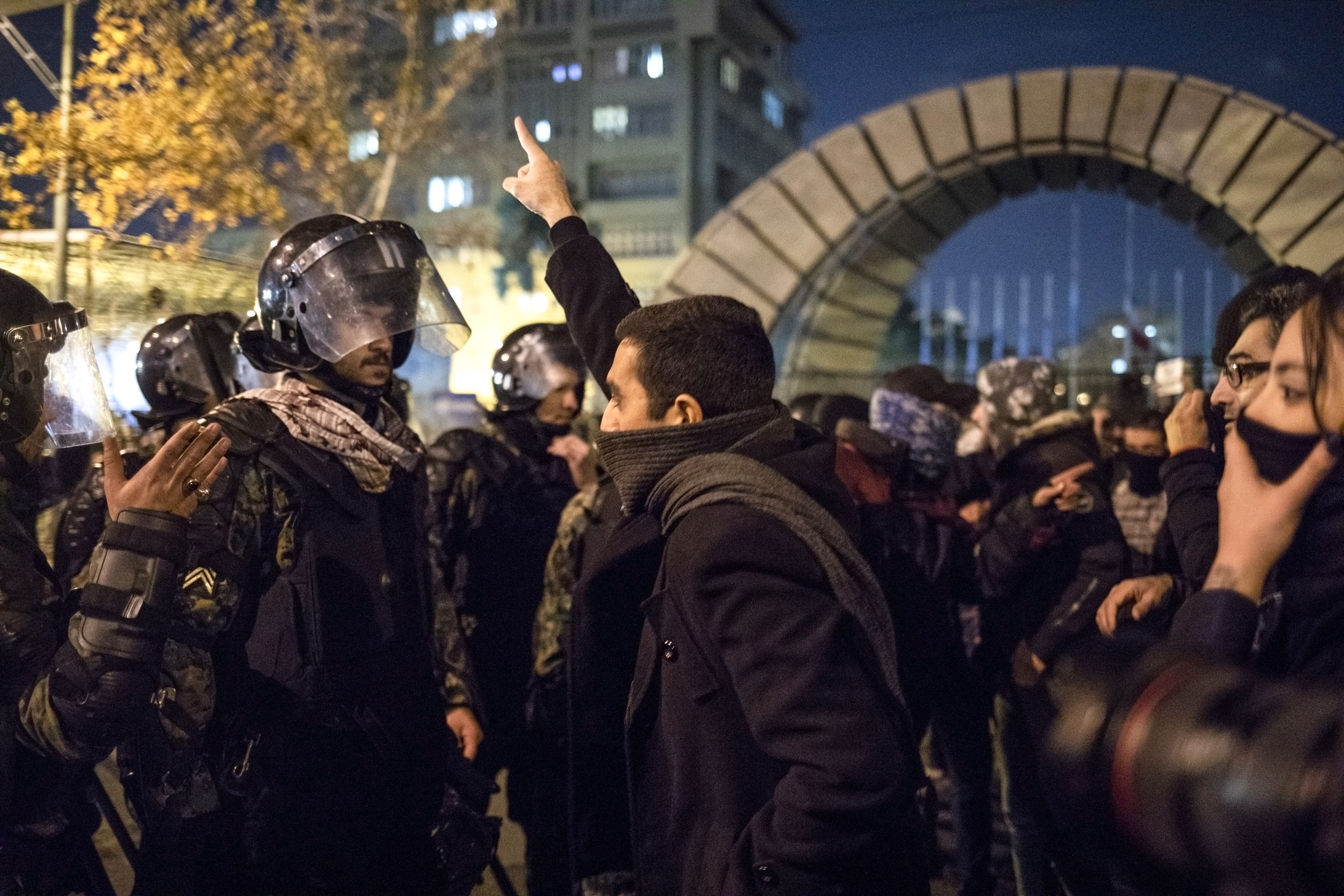  A man confronts riot police outside Tehran's Amir Kabir University. 