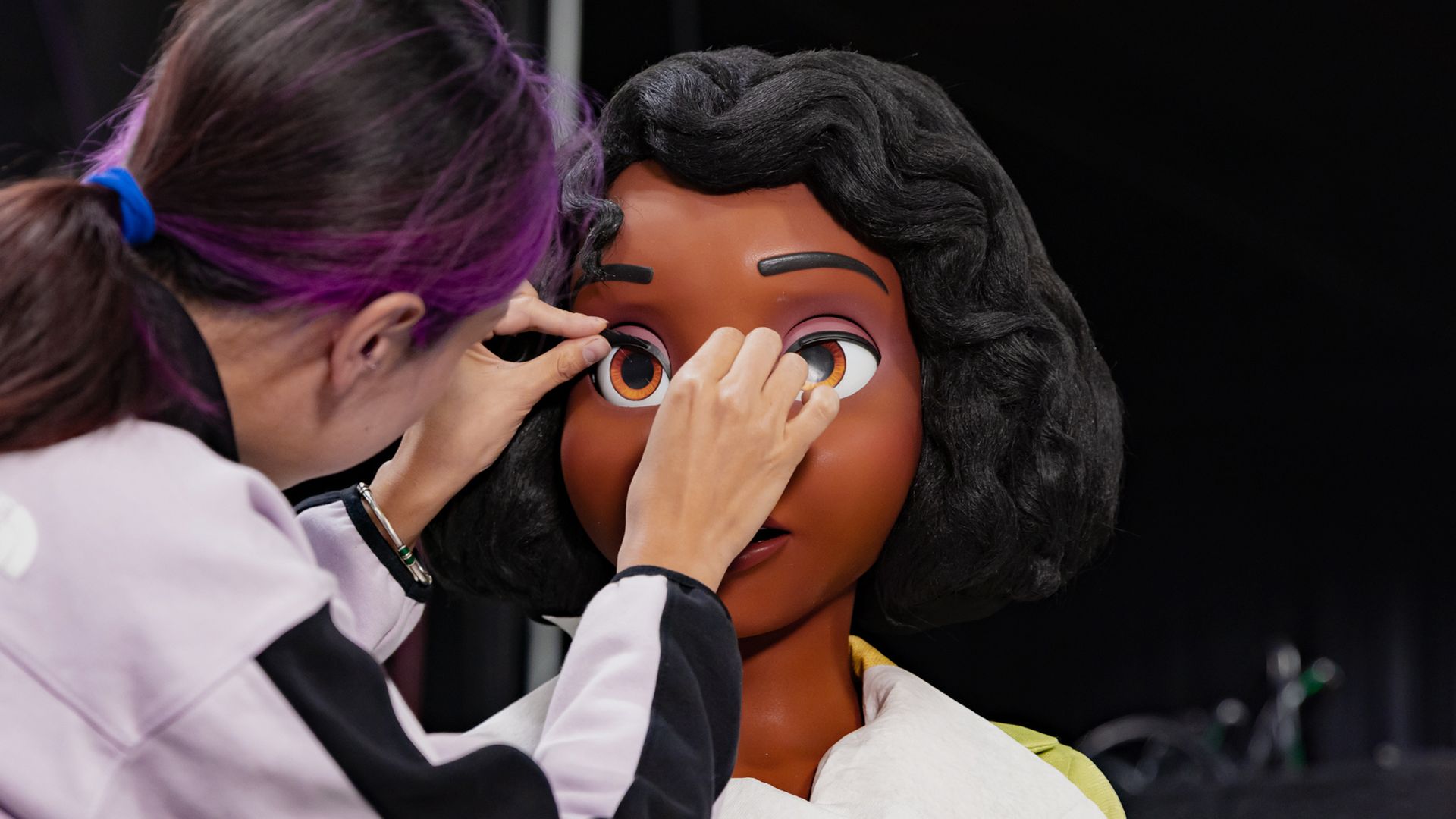 Photo shows a Disney artist working on the animatronic version of Princess Tiana