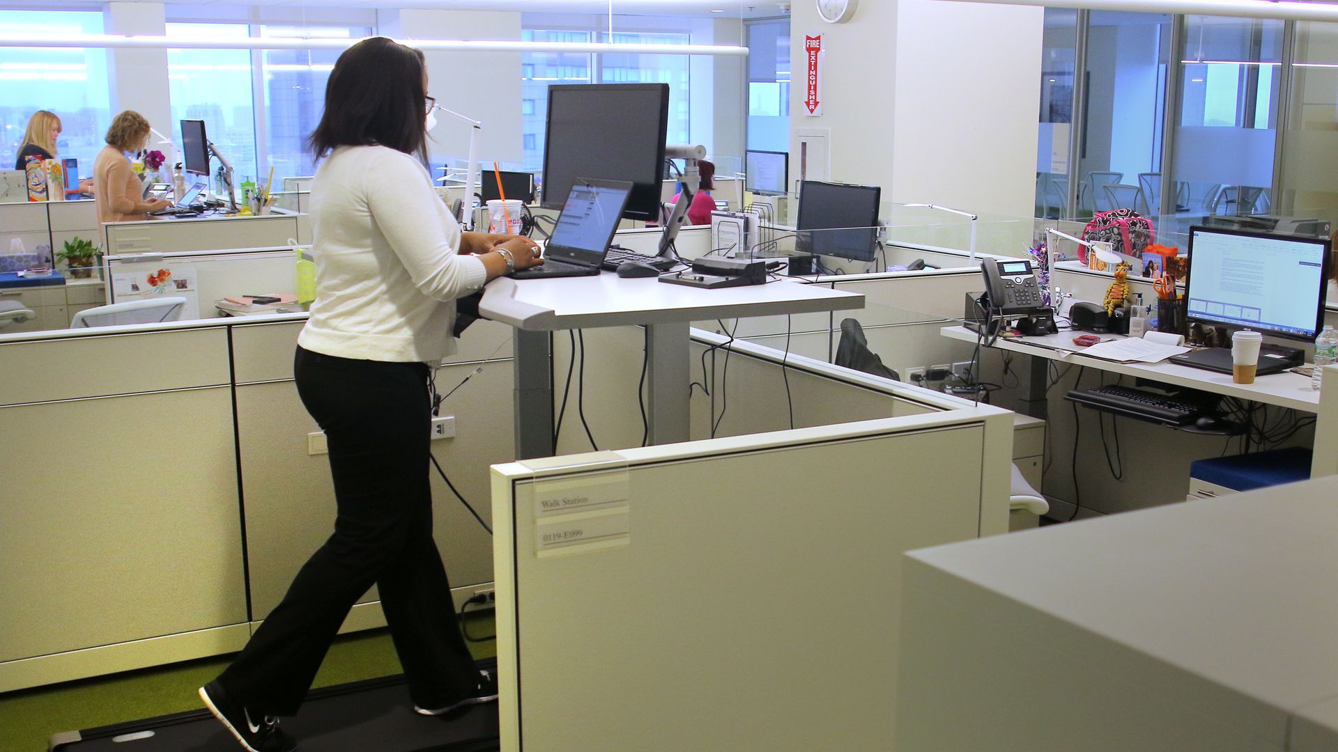A woman on a treadmill at work. 