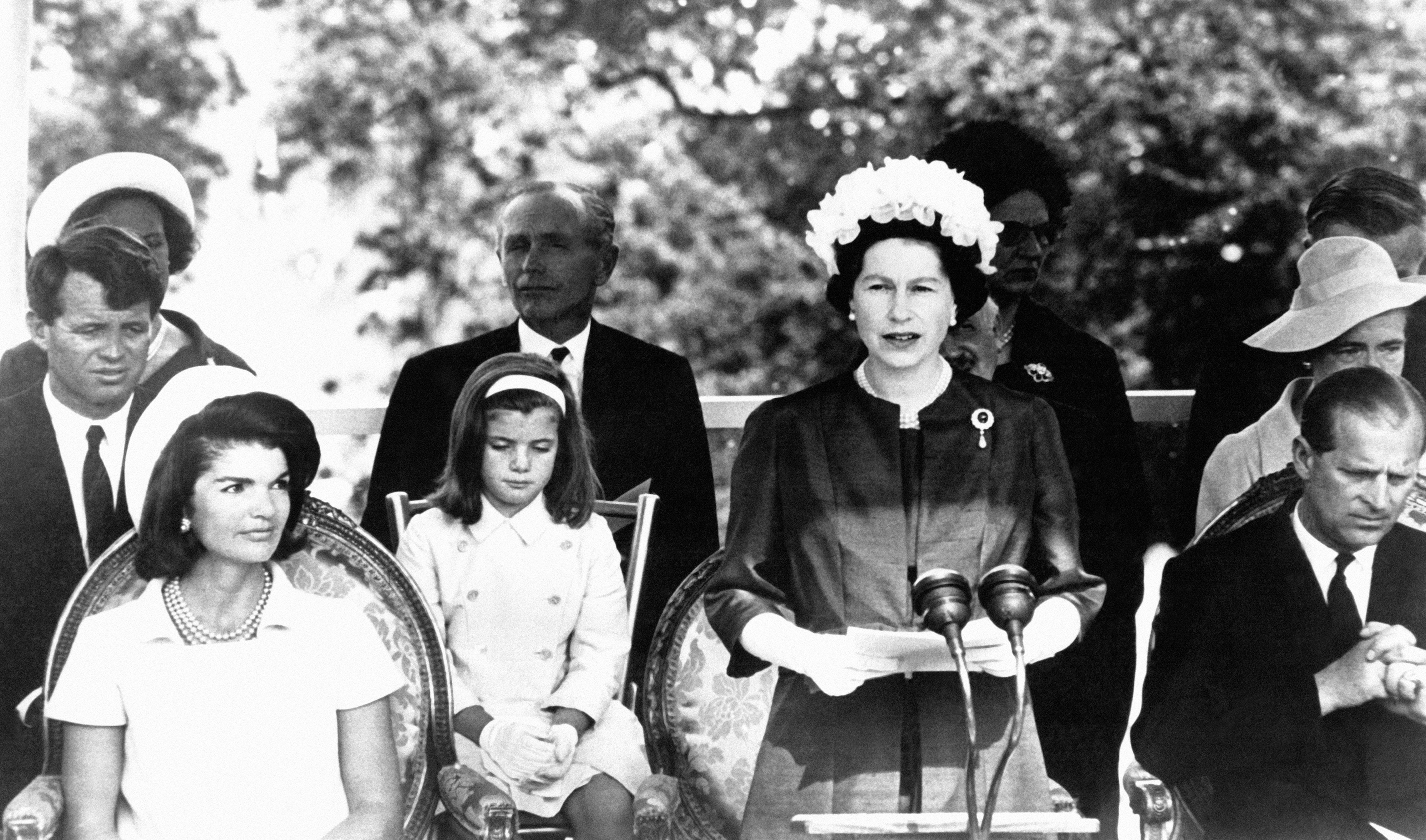 Prime Minister Alec Douglas-Home (middle left) watches as Queen Elizabeth speaks in 1965.