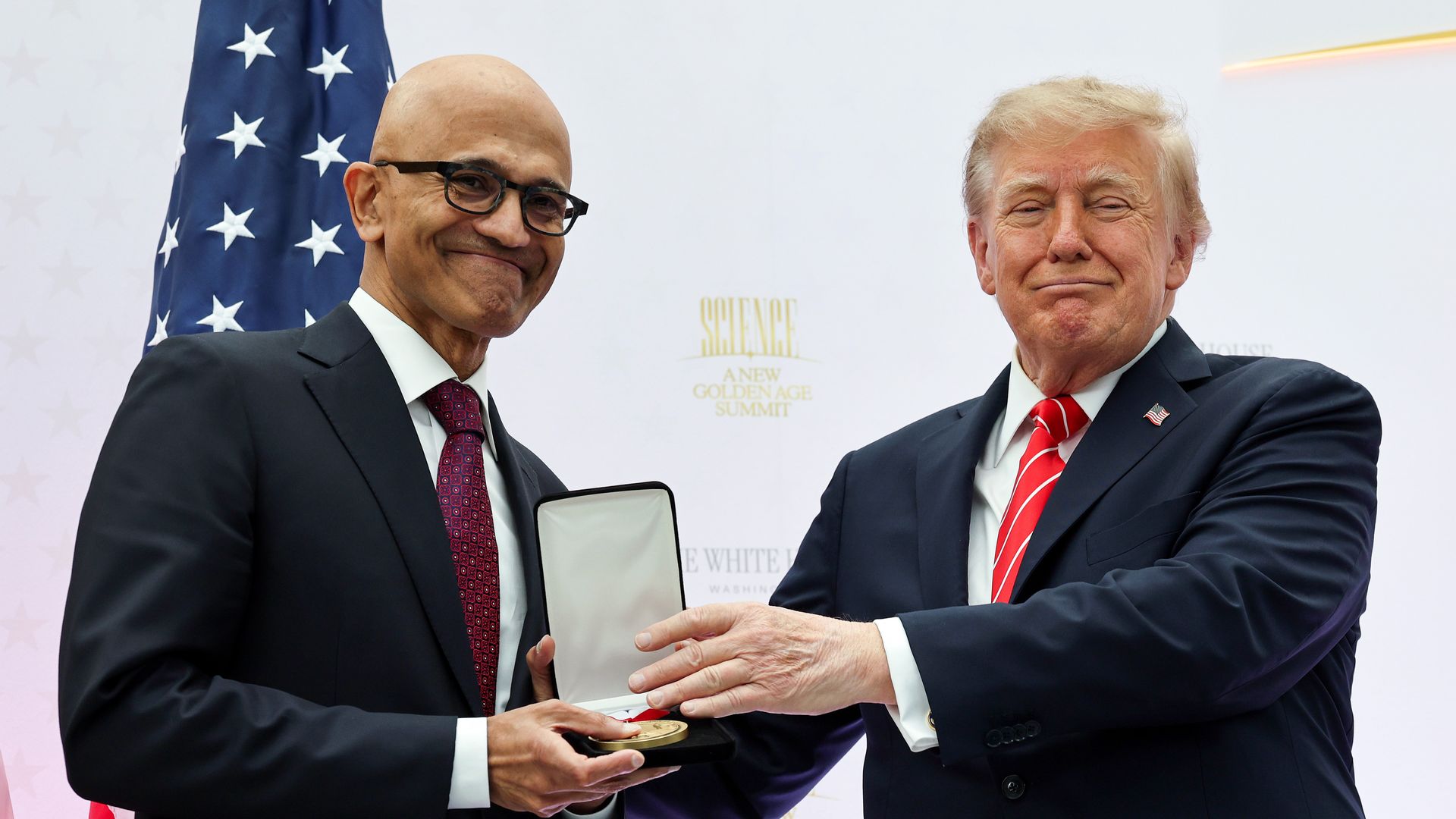 Satya Nadella getting an award from Donald Trump at the White House