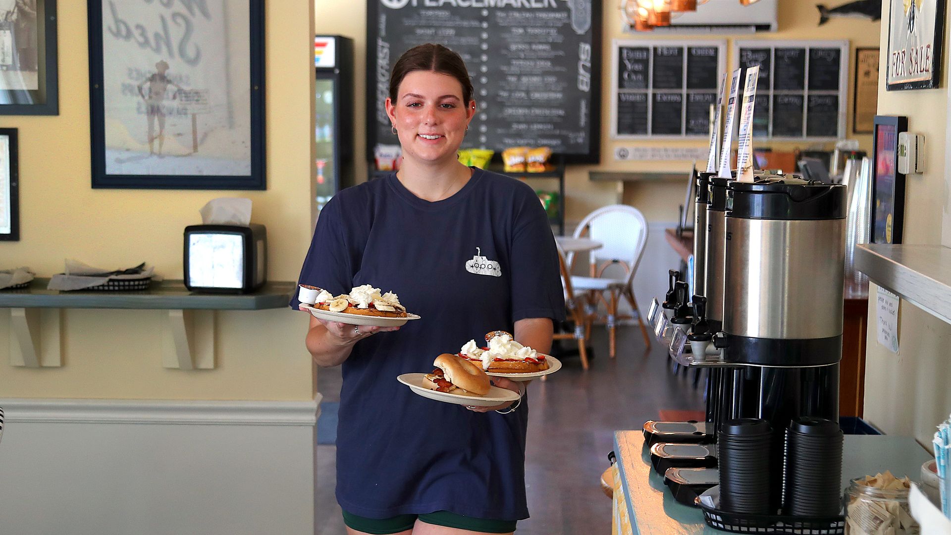 A teen serves pancakes on Cape Cod