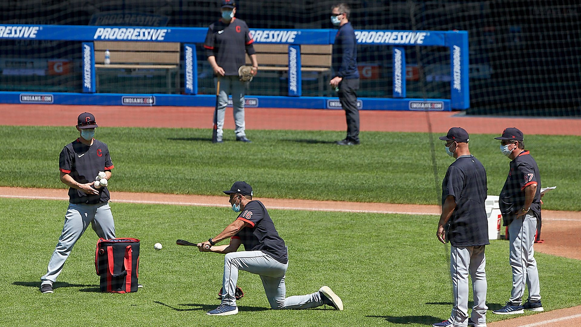 Players for the Cleveland Indians are on the field preparing for a summer workout