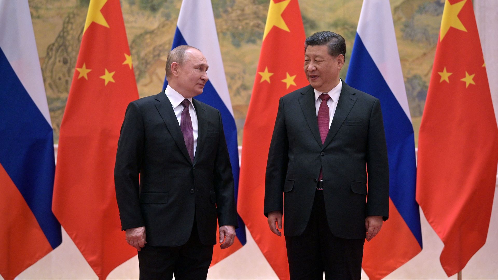 Russian President Vladimir Putin (L) and Chinese President Xi Jinping pose during their meeting in Beijing, on February 4, 2022.