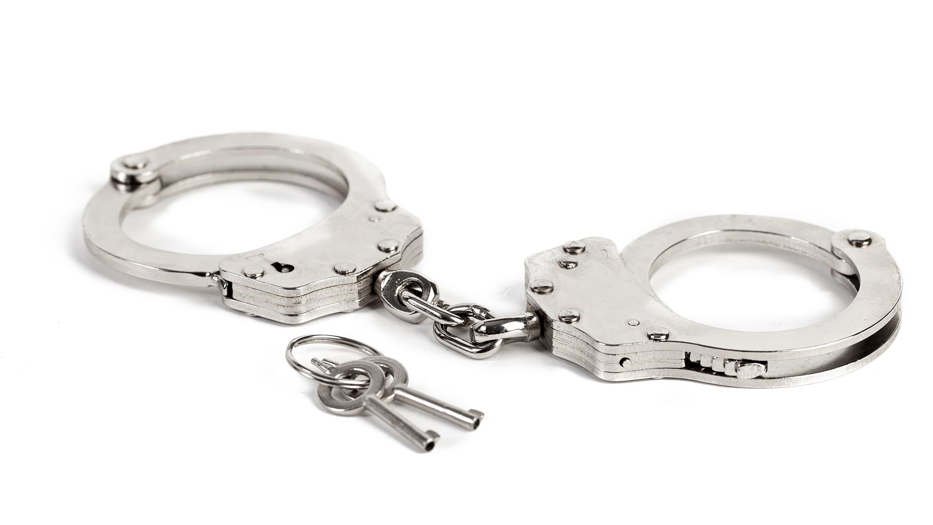 High Angle View Of Handcuffs Against White Background