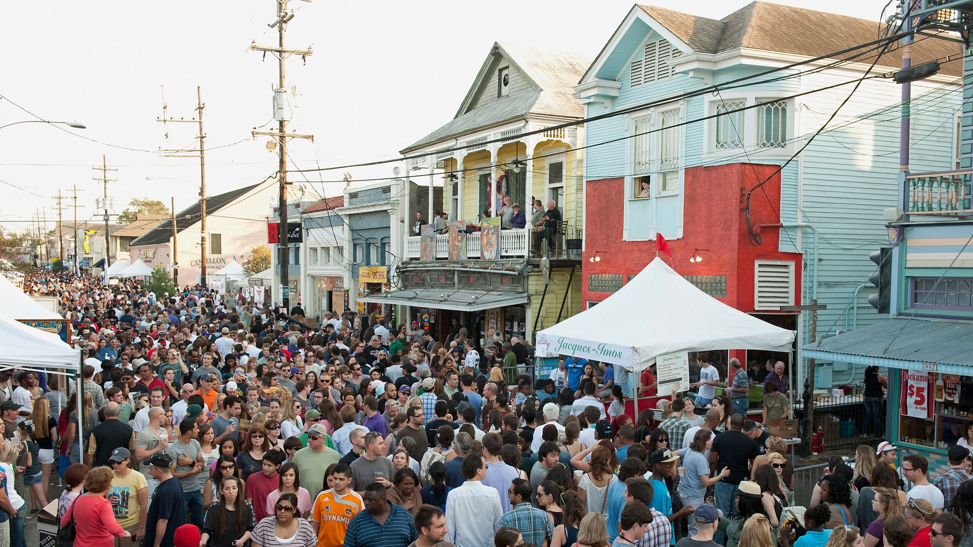 Oak Street is filled with people walking between tents and buildings.