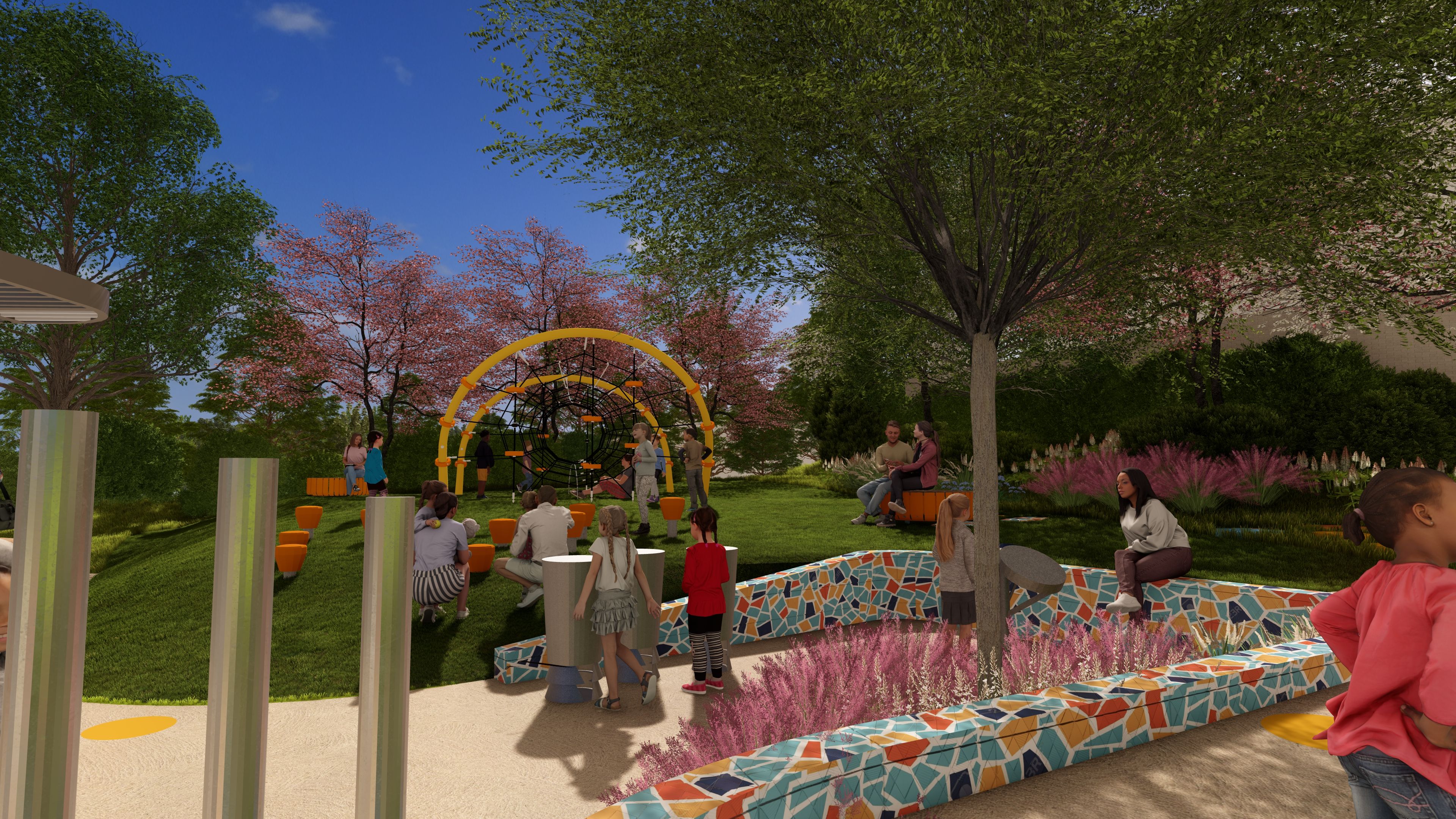 Sunny park playground with a yellow circular climbing structure, mosaic benches, pink flowering trees, green grass, and groups of people relaxing.