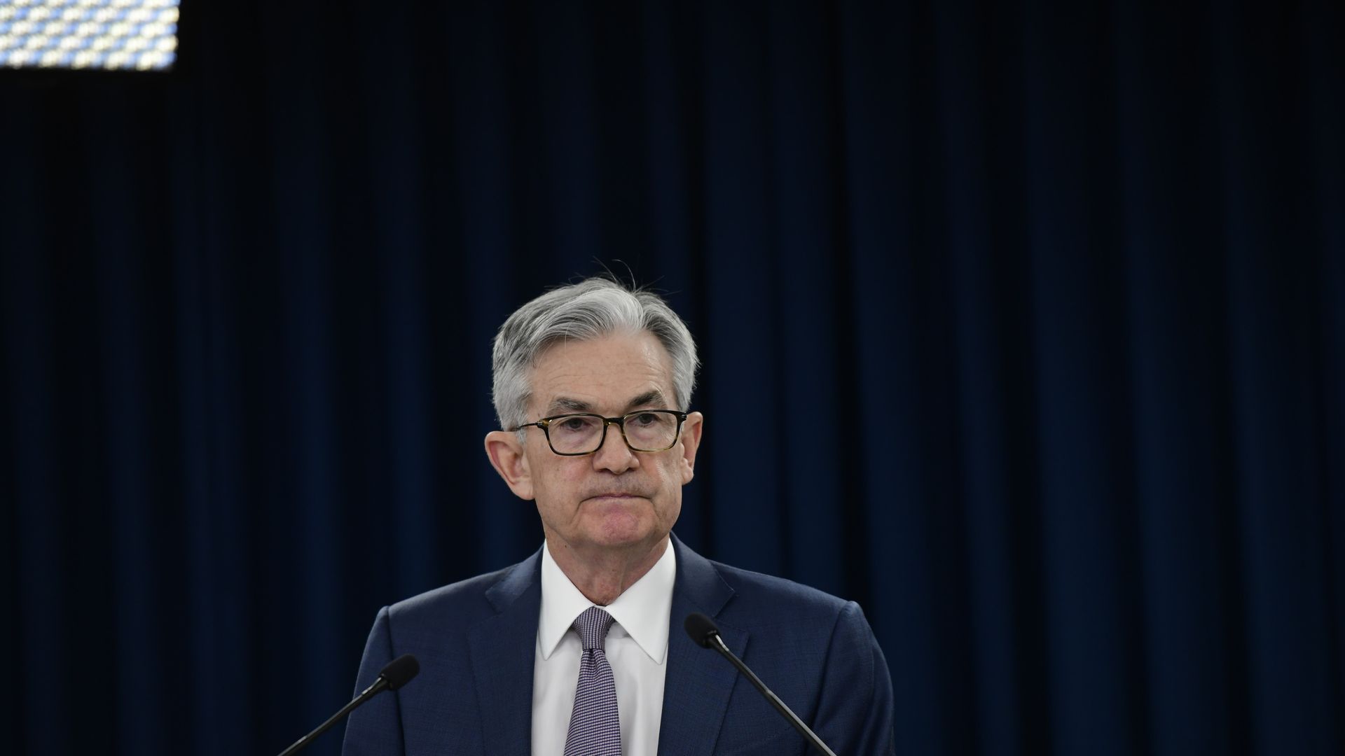 Fed Chair Jerome Powell standing behind a podium