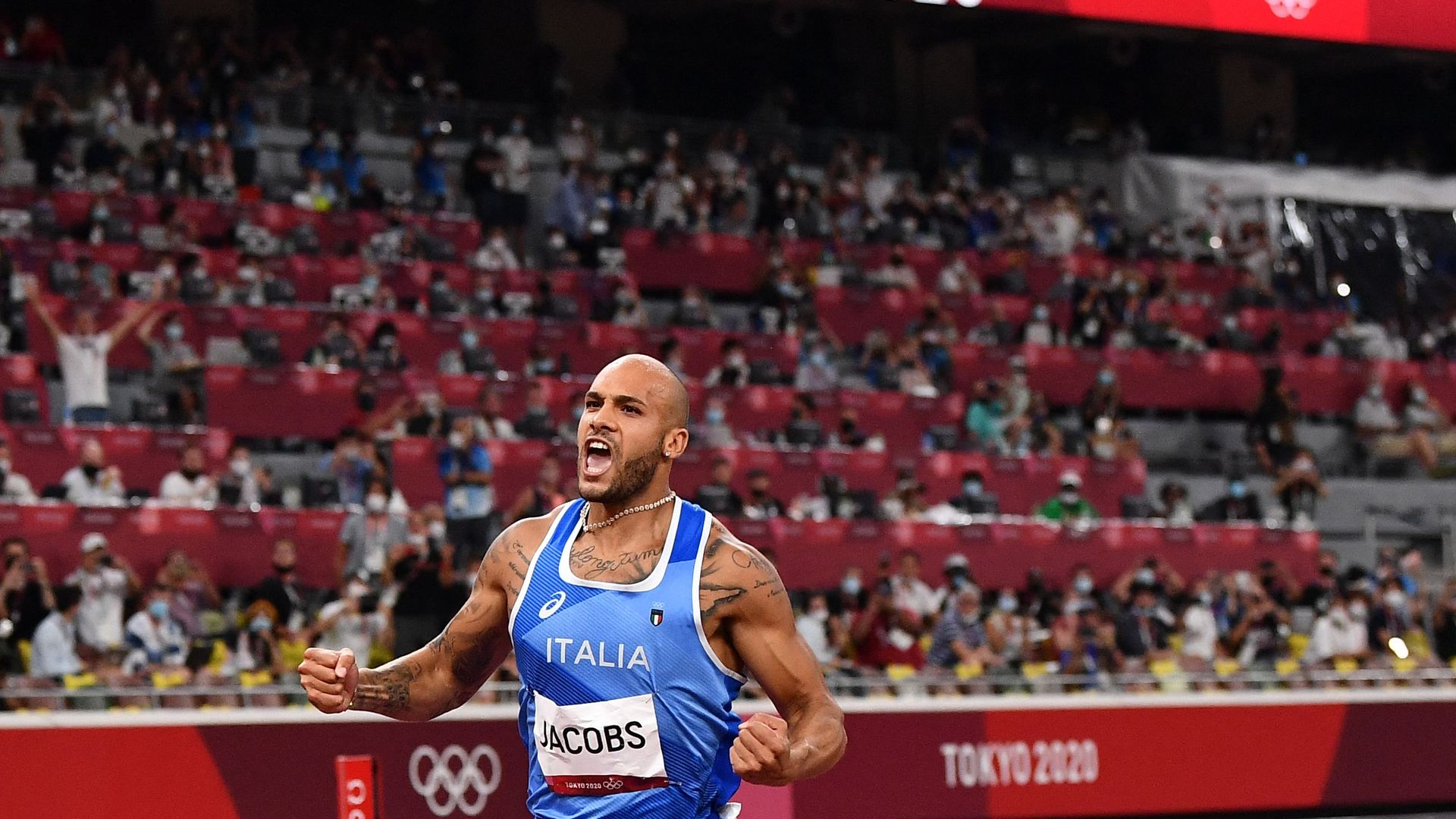  Italy's Lamont Marcell Jacobs celebrates as he crosses the finish line to win the men's 100m final during the Tokyo 2020 Olympic Games on August 1