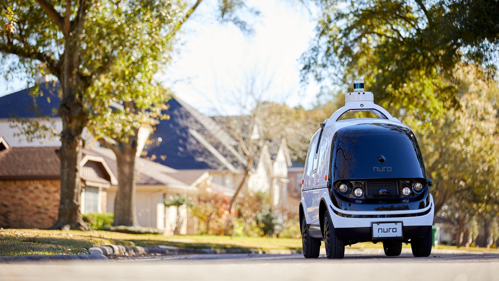 Image of Nuro driverless delivery vehicle on a suburban street. 