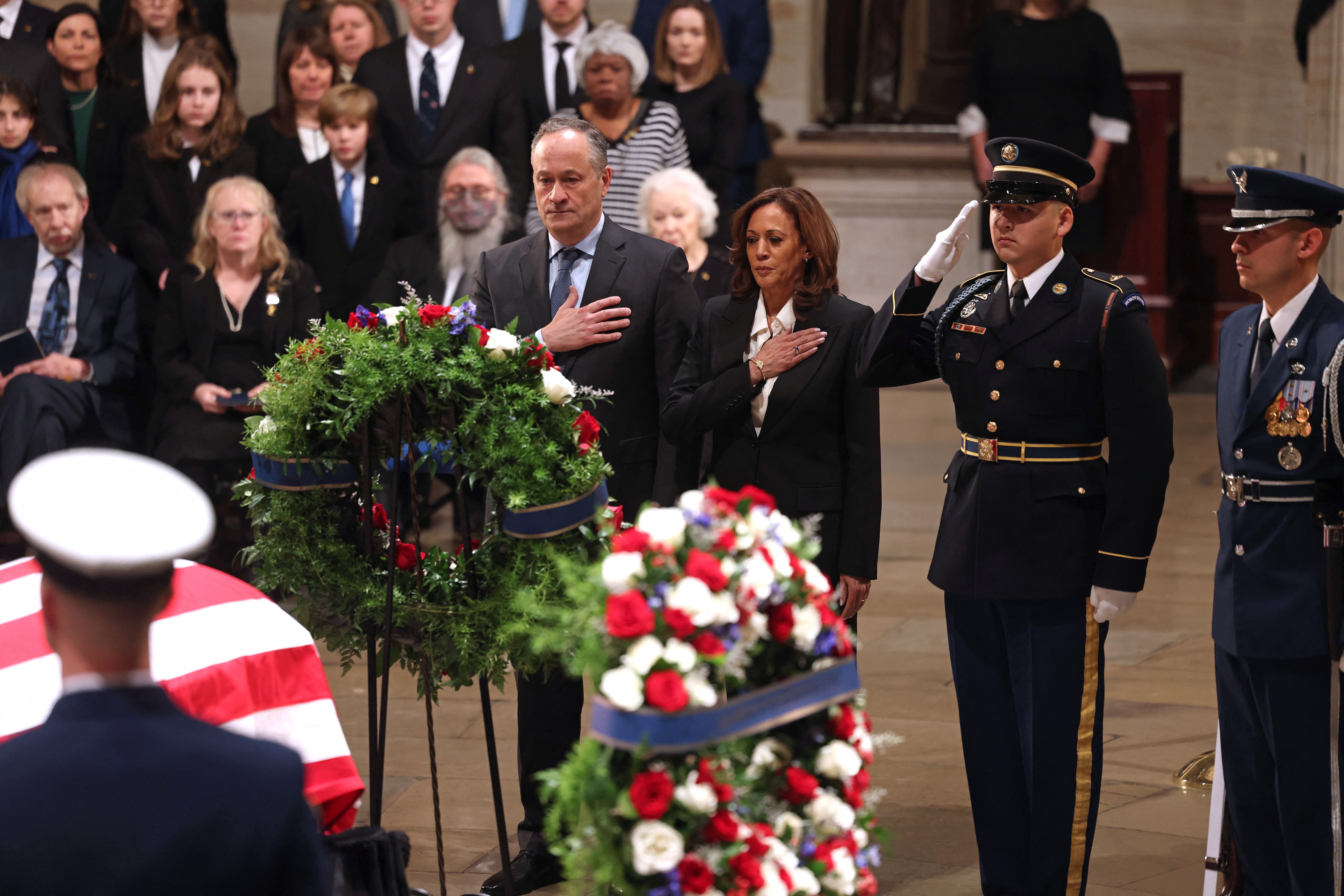 US Vice President Kamala Harris (C), alongside US Second Gentleman Doug Emhoff, presents a wreath on behalf of the Executive Branch at the Lying in State Ceremony for former President Jimmy Carter at the US Capitol Rotunda in Washington, DC on January 7, 2025. Carter, the 39th President of the Unite