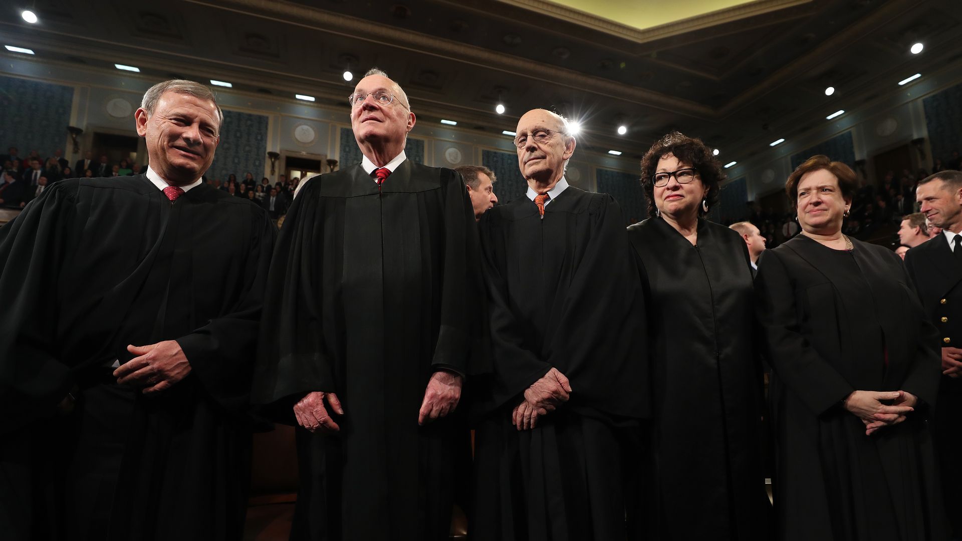 Justices of the Supreme Court of the United States stand in a row.