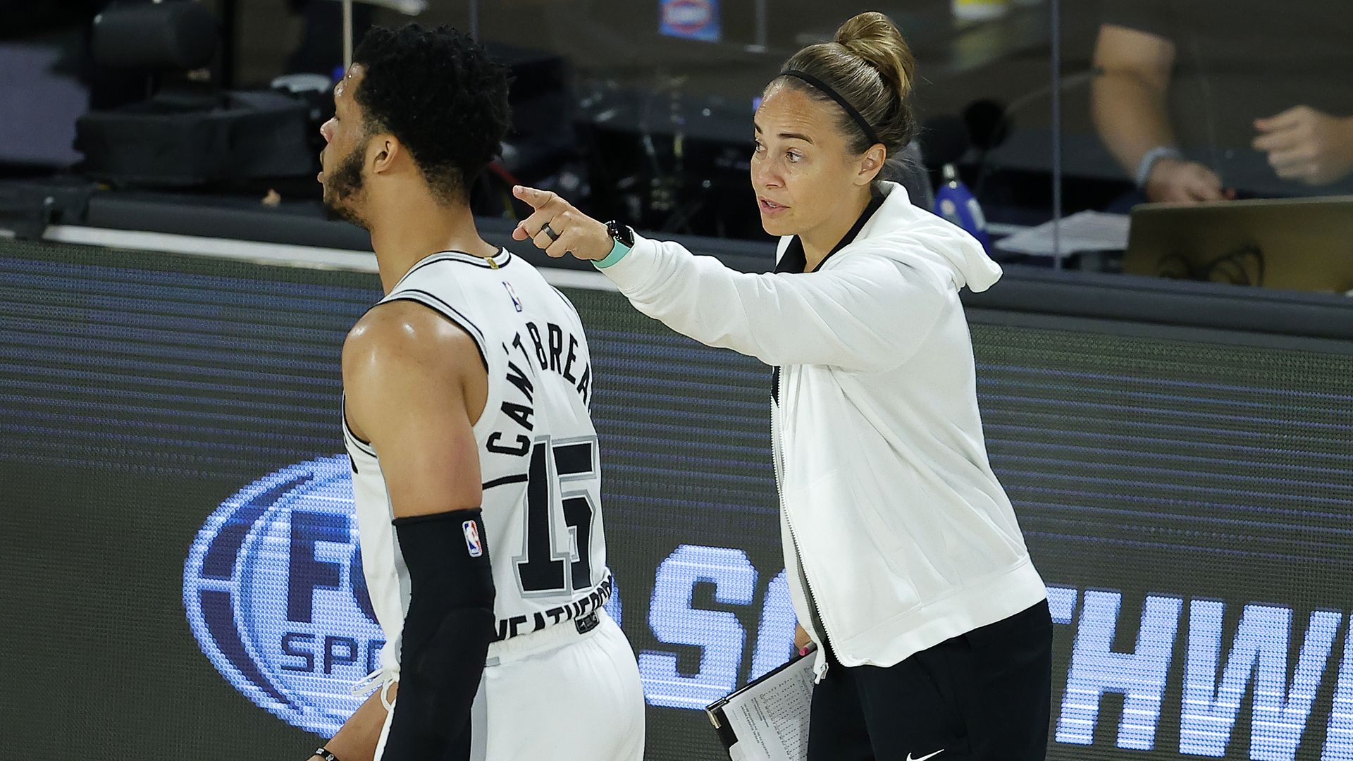 Spurs assistant coach Becky Hammon talks with Quinndary Weatherspoon #15 of the San Antonio Spurs against the Utah Jazz at HP Field House at ESPN Wide World Of Sports Complex on August 07