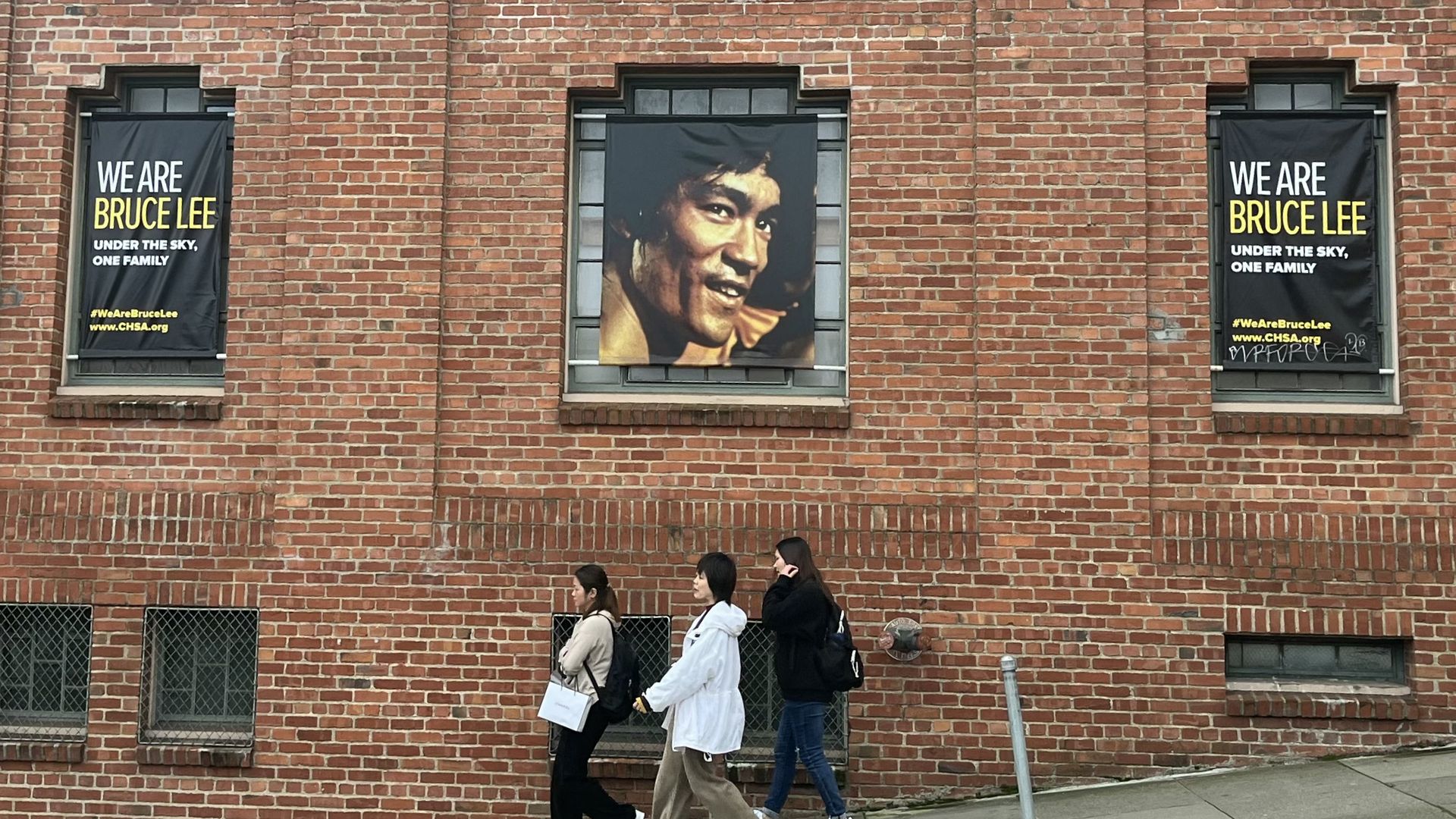Photo of Bruce Lees picture in a window on a street