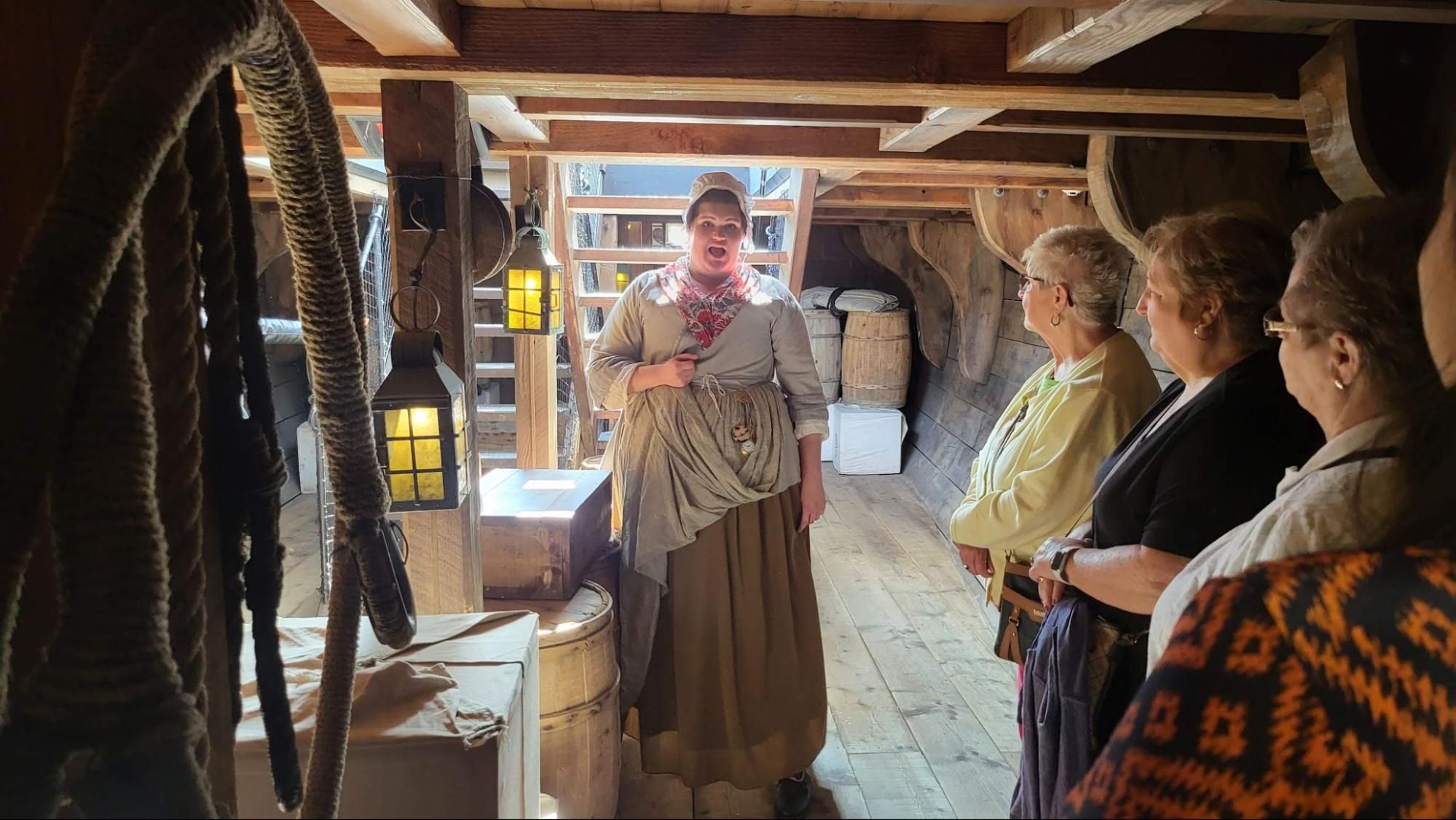 A Museum Tea Party Museum actor dressed in a ratty dress takes tourists aboard the Eleanor.