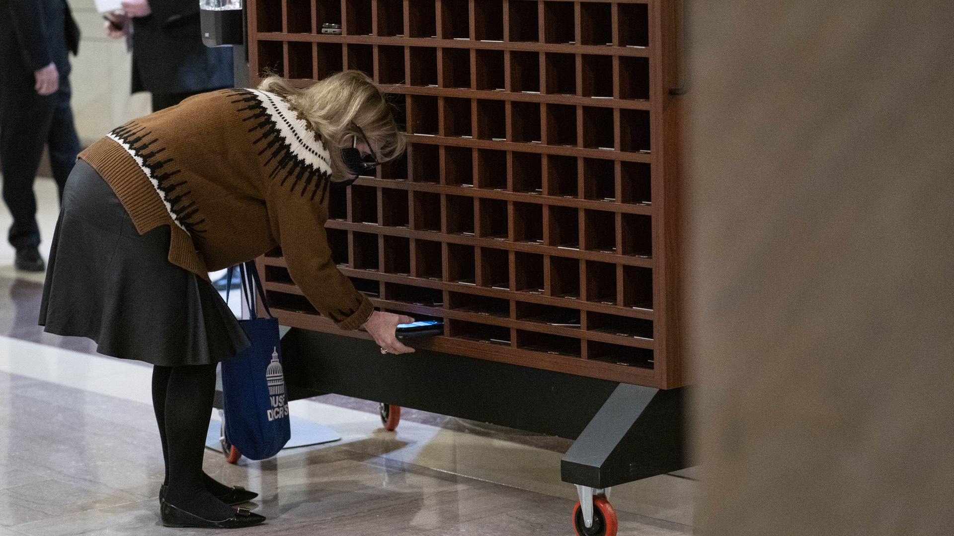 Rep. Debbie Dingell is seen storing her cellphone before walking into a classified briefing about the Jan. 6 Capitol attack.