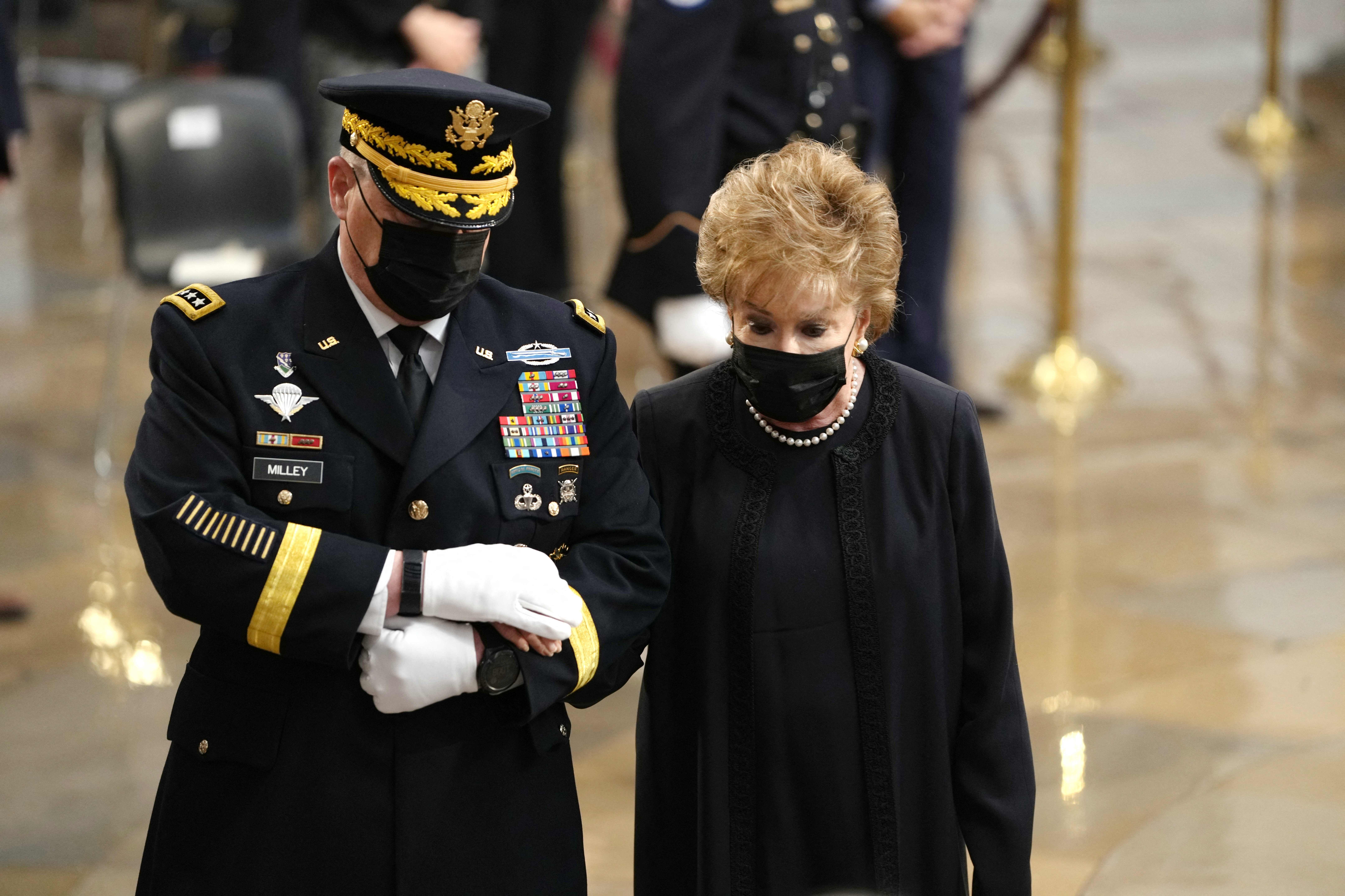 Elizabeth Dole, the wife of Bob Dole, being escorted in the Capitol on Dec. 9.
