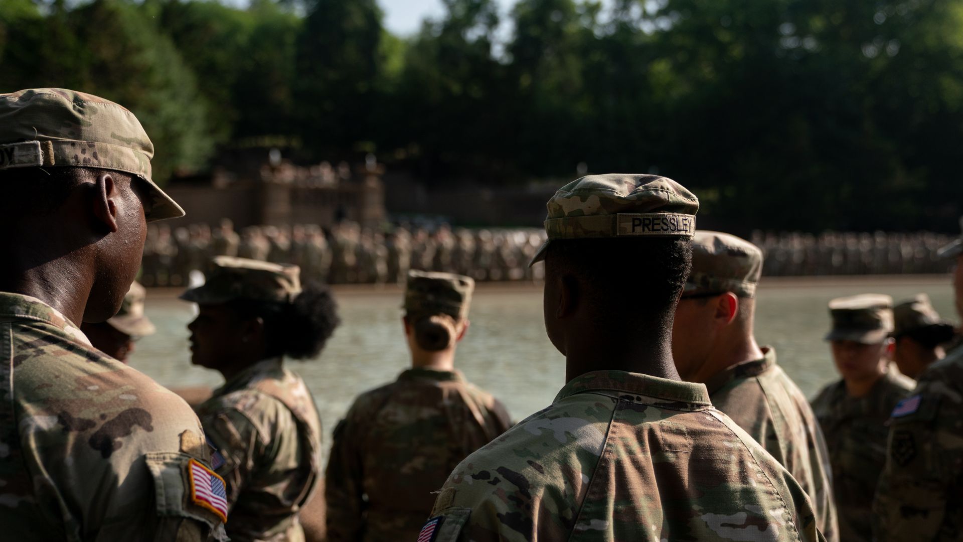 A large group of National Guard troops, with more in the background, gathered around the fountain at Meridian Hill Park