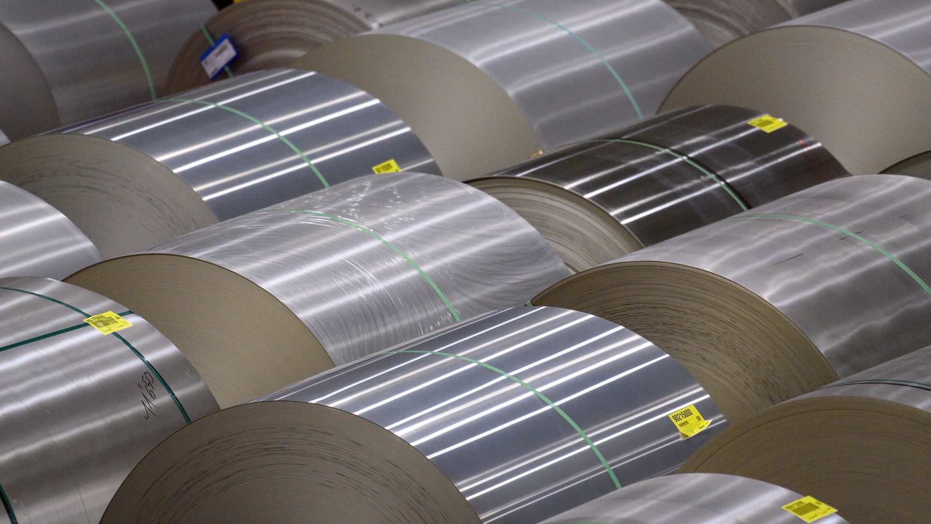 Rolls of aluminum laying on their sides. 