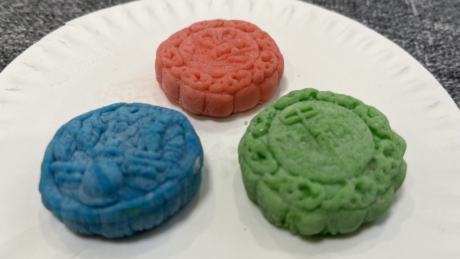 Three multi-colored mooncakes made out of play doh
