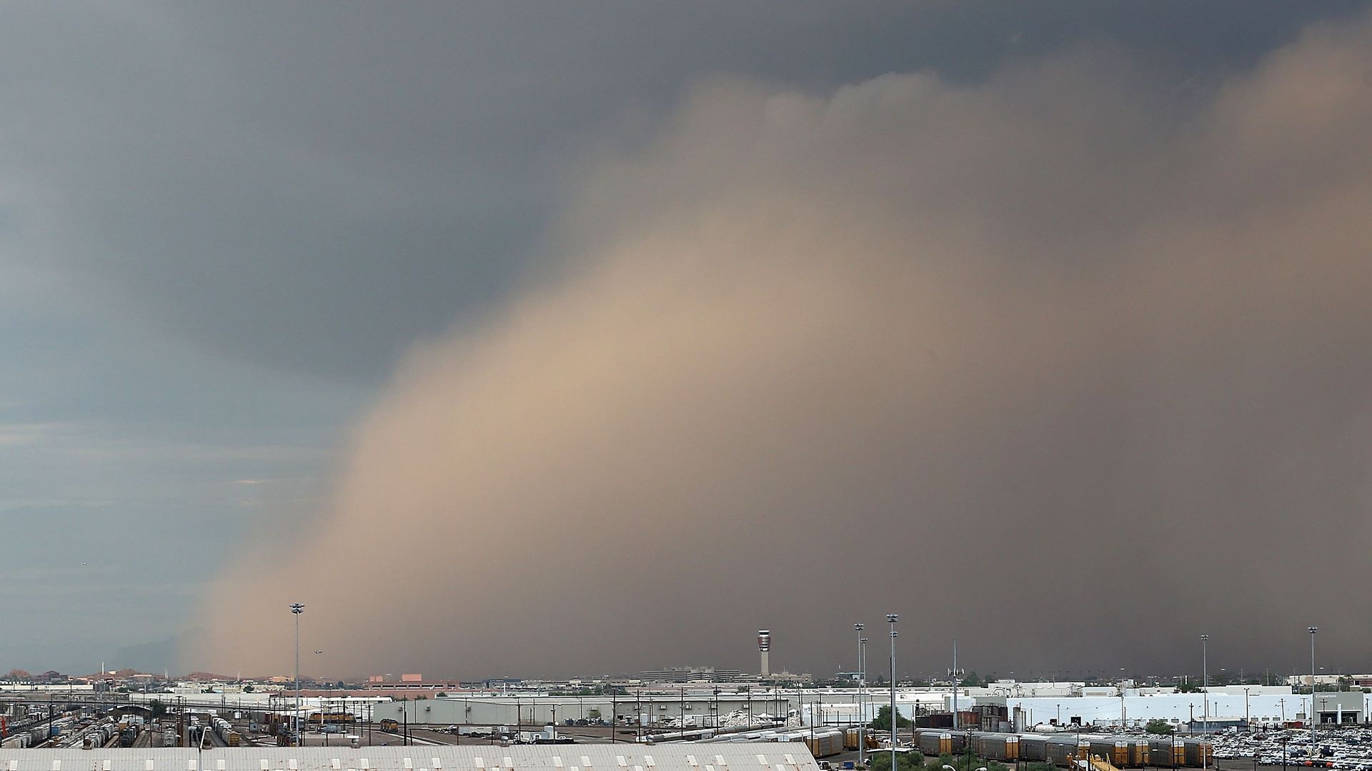 A dust storm rolls over an urban landscape.