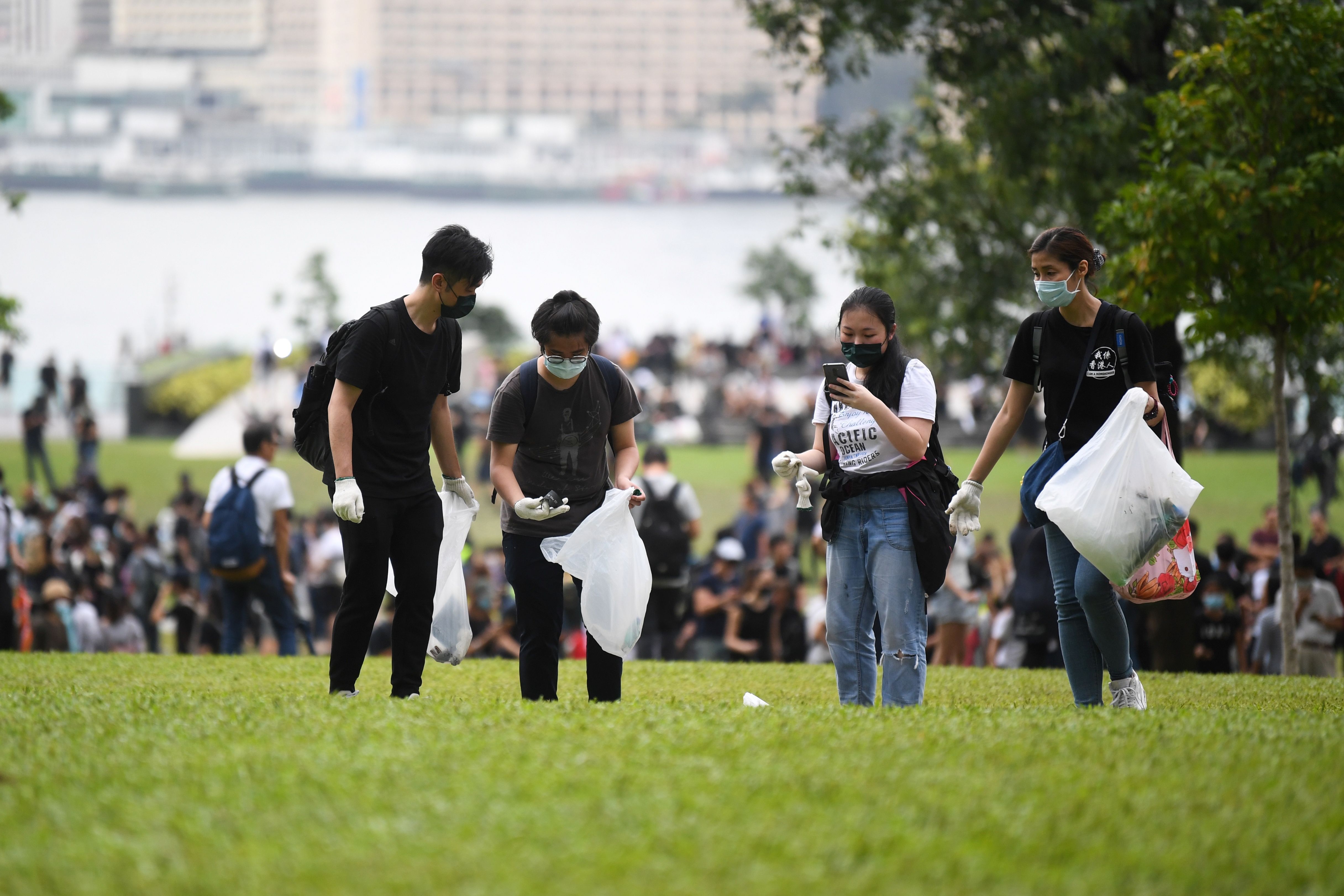 Volunteers clean debris from a park near the government headquarters in Hong Kong.