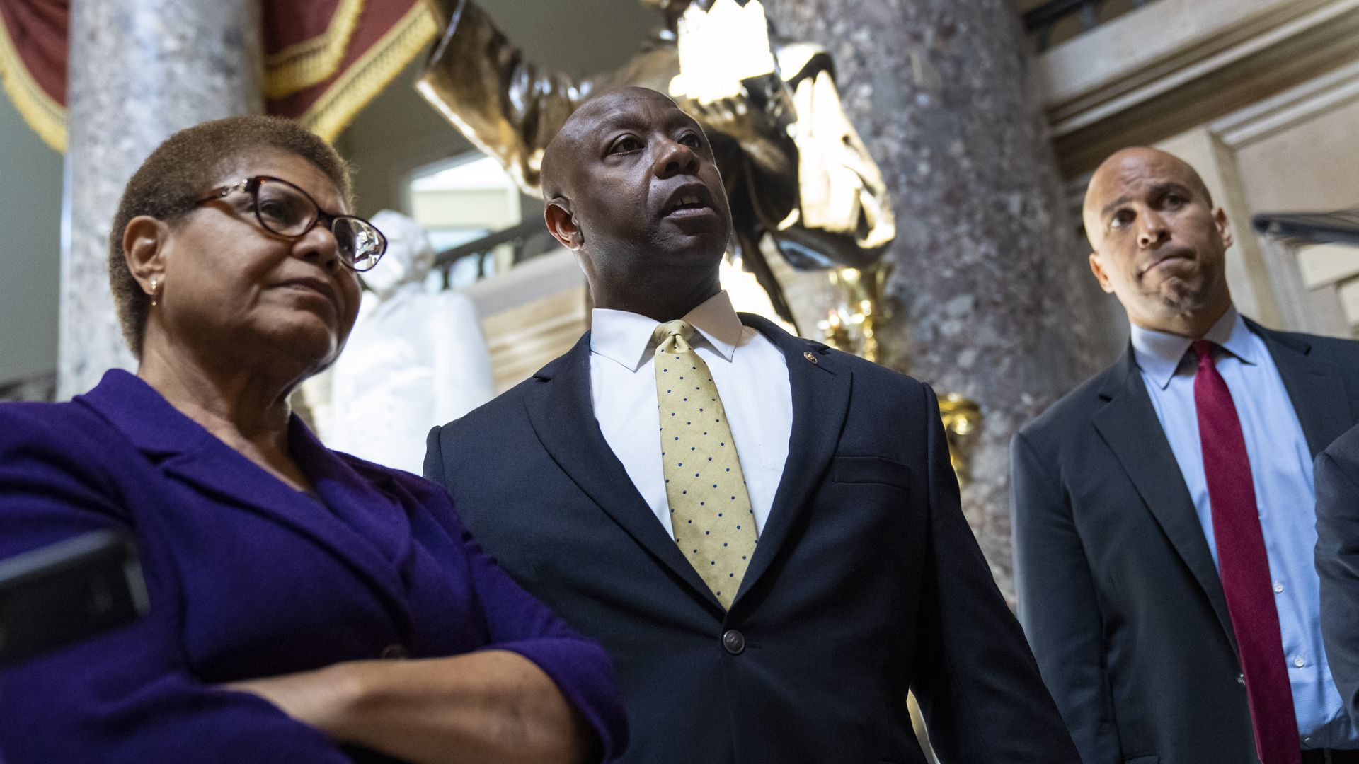 Photo of Tim Scott, Karen Bass and Cory Booker speaking to reporters in the Capitol