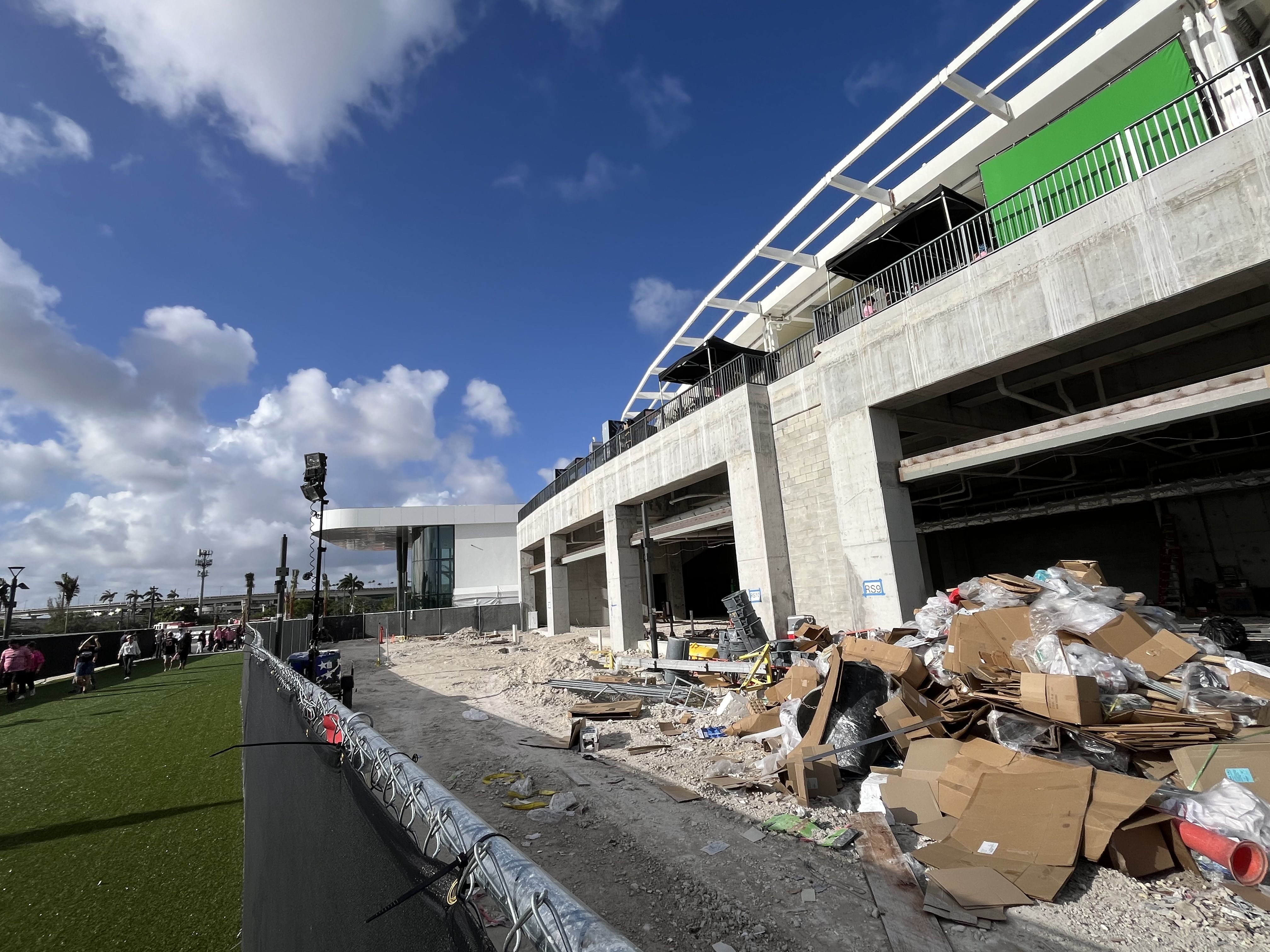 Black tarp-lined fences cover up construction debris outside the stadium.