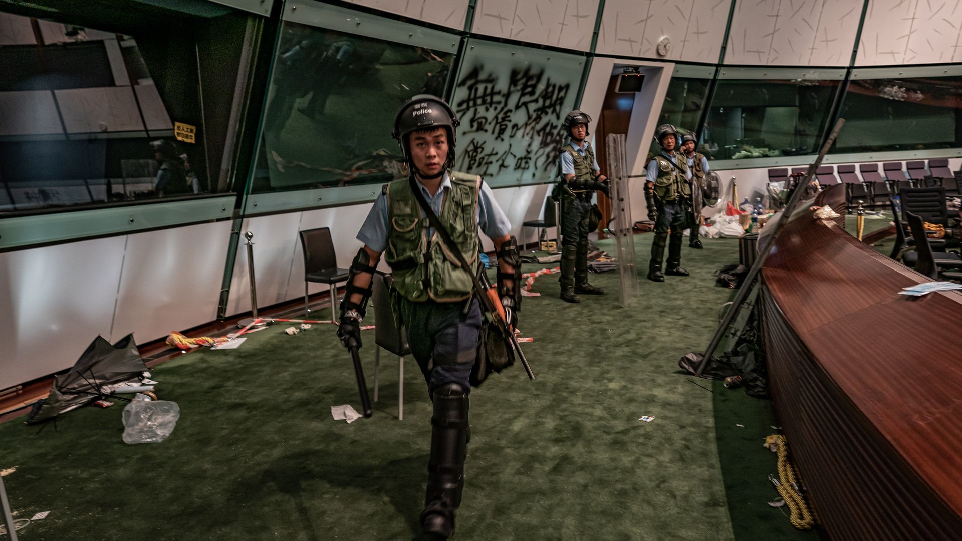 Riot police patrol inside the Legislative Council building.