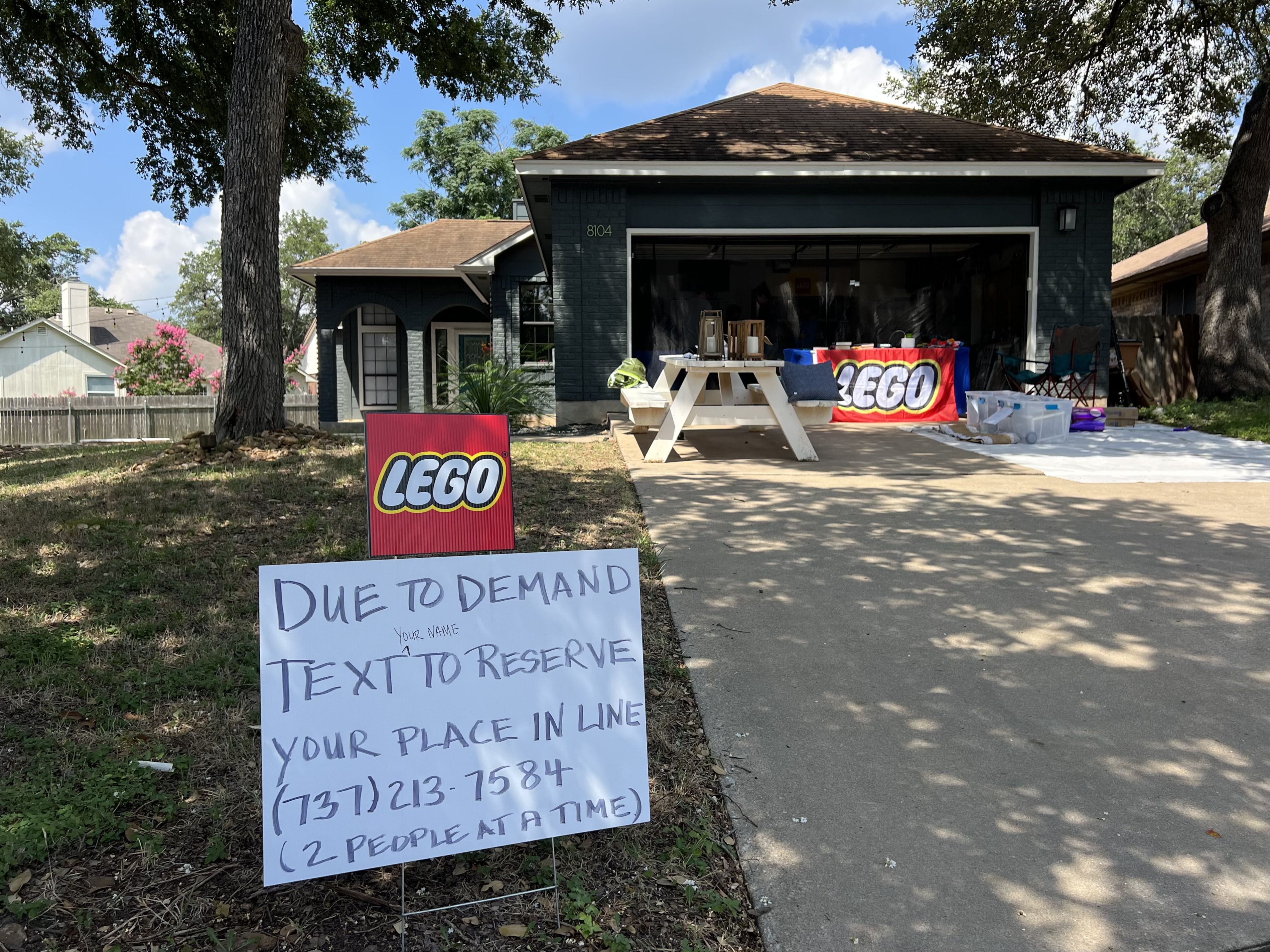 A photo of a sign reading "LEGO. Due to demand text to reserve your place in line."