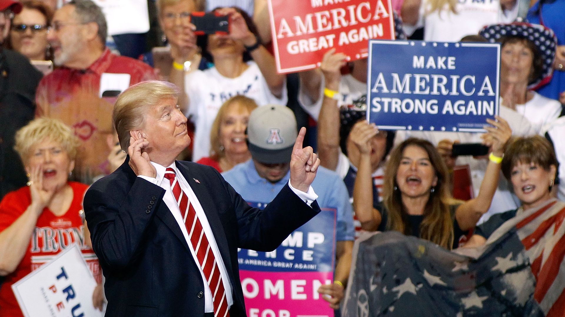 President Trump gestures to the crowd of supporters at the Phoenix Convention Center 